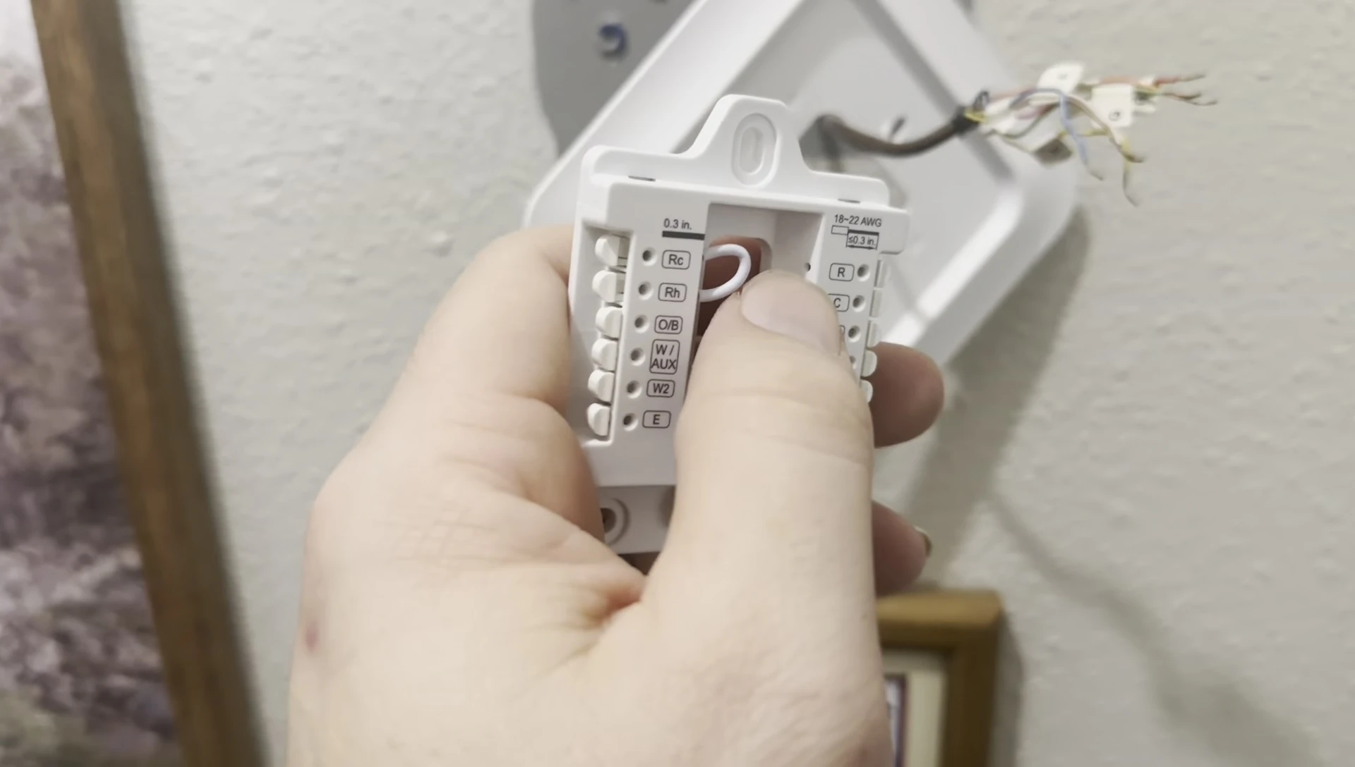The reviewer shows how the wires are connected from the back