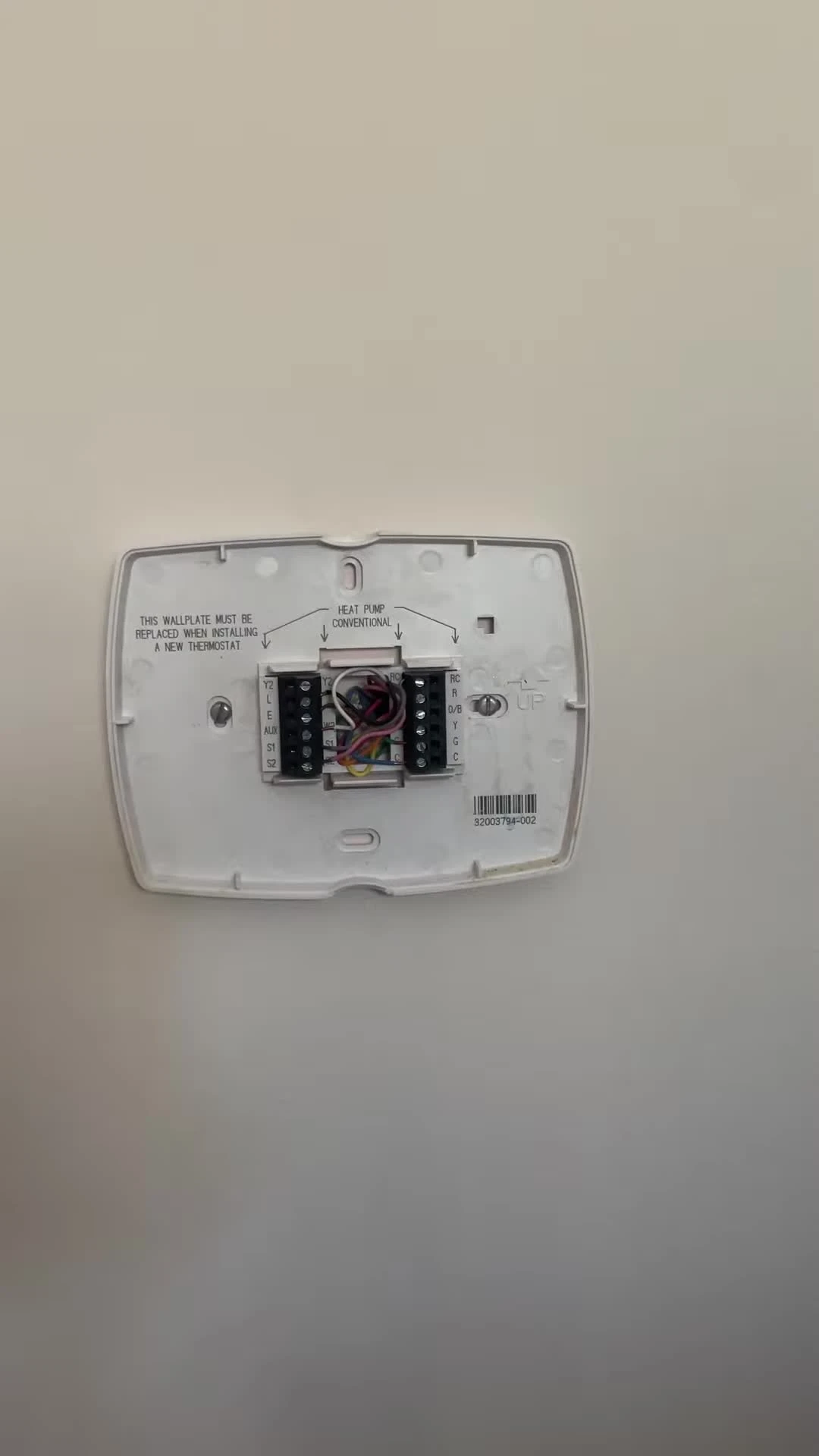 Disconnecting wires from the old thermostat and taking a picture.