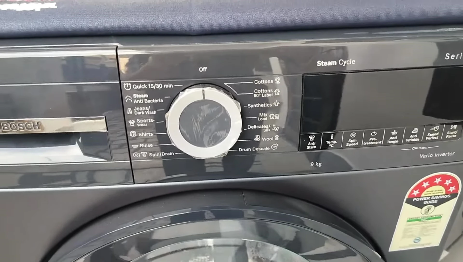 The digital display showing wash cycle details, such as temperature and time.