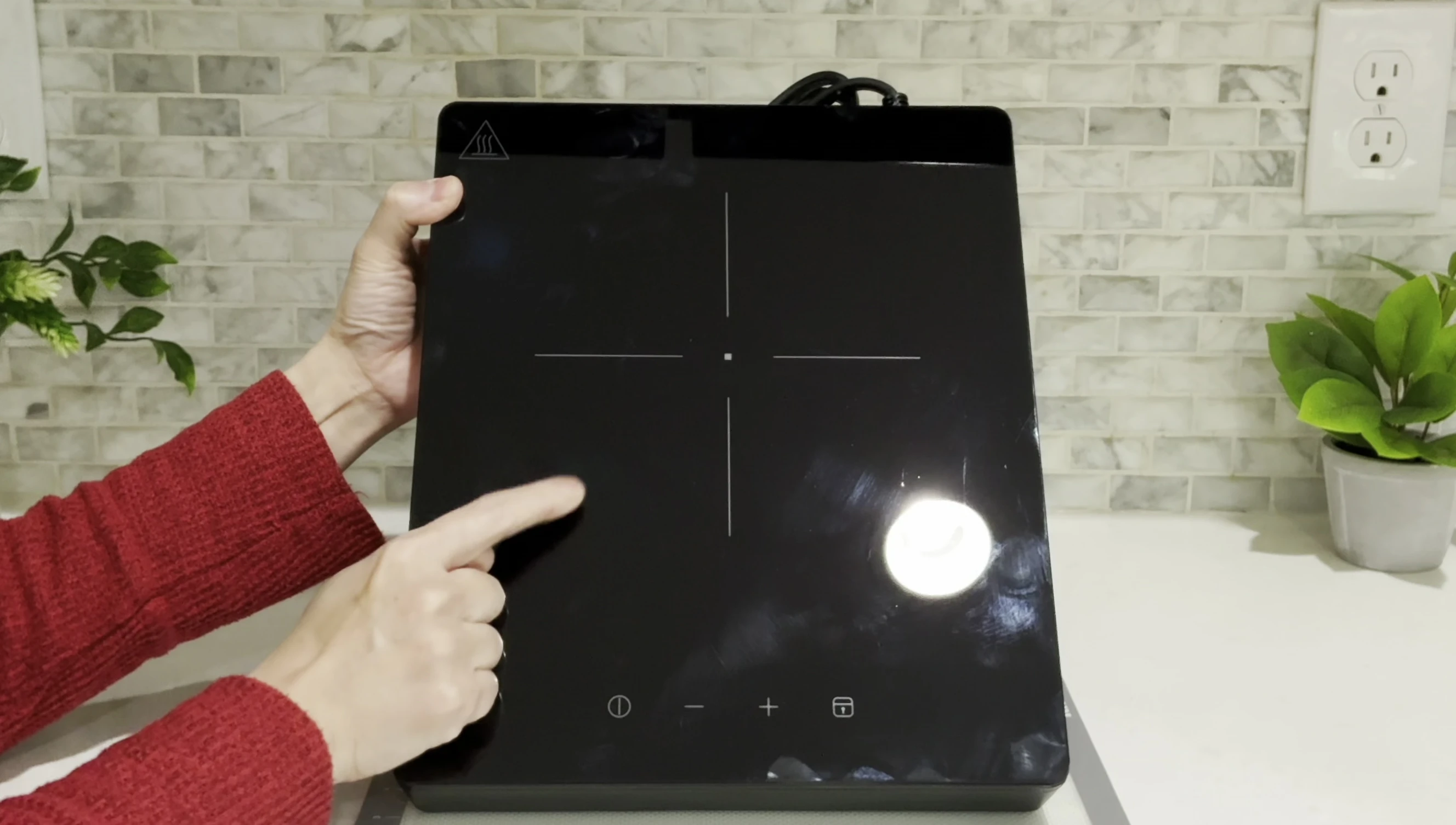 Close-up view of the cross-shaped heating element on the cooktop.