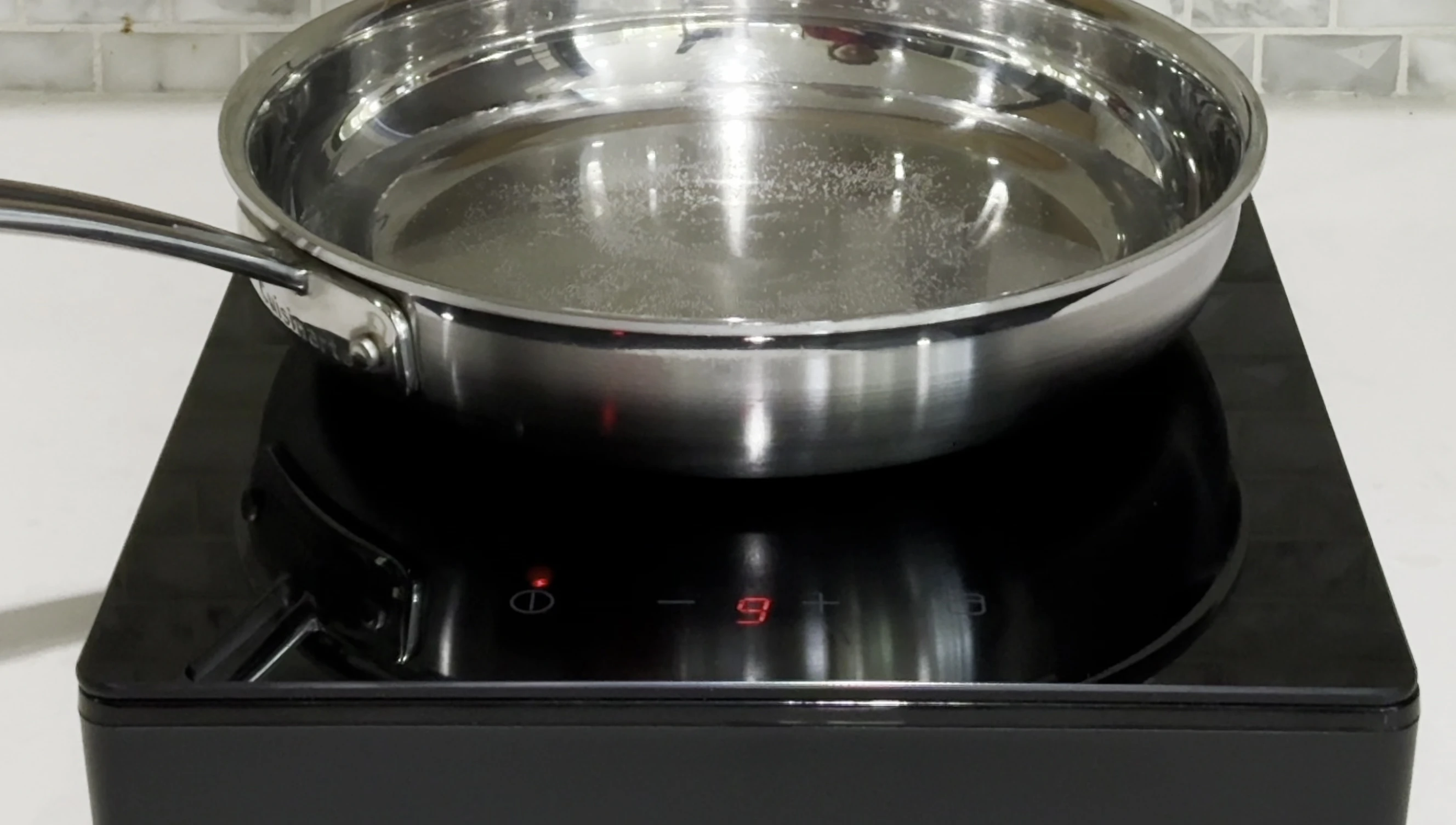 Cooktop in operation, showing water boiling
