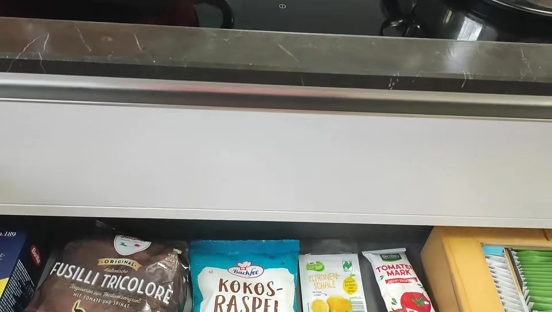 View of under-cooktop storage