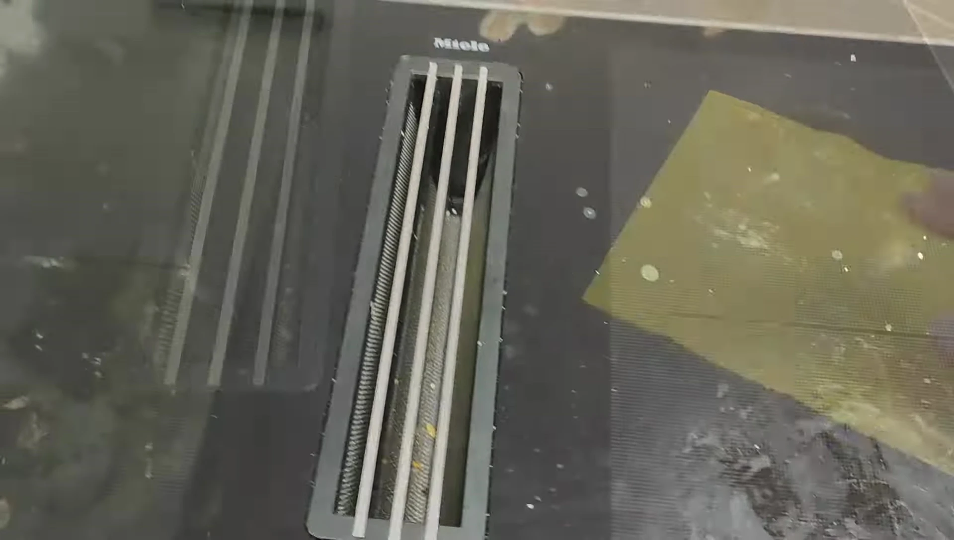 Cleaning the cooktop with a soapy sponge