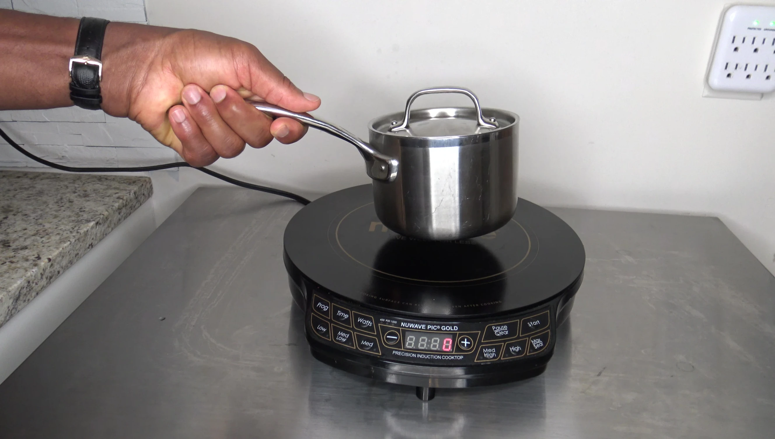 Close-up showing the heating ring and a pot placed on the cooktop
