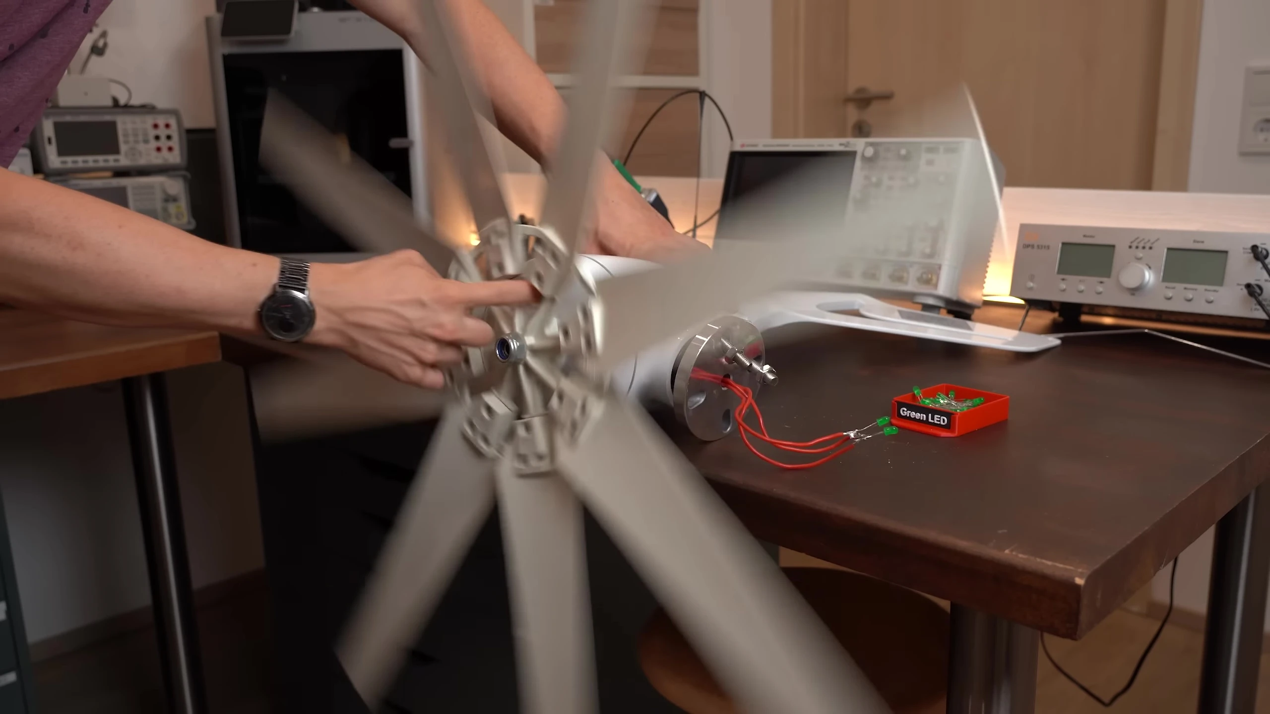 LEDs lighting up sequentially as the rotor turns, confirming three-phase AC output.