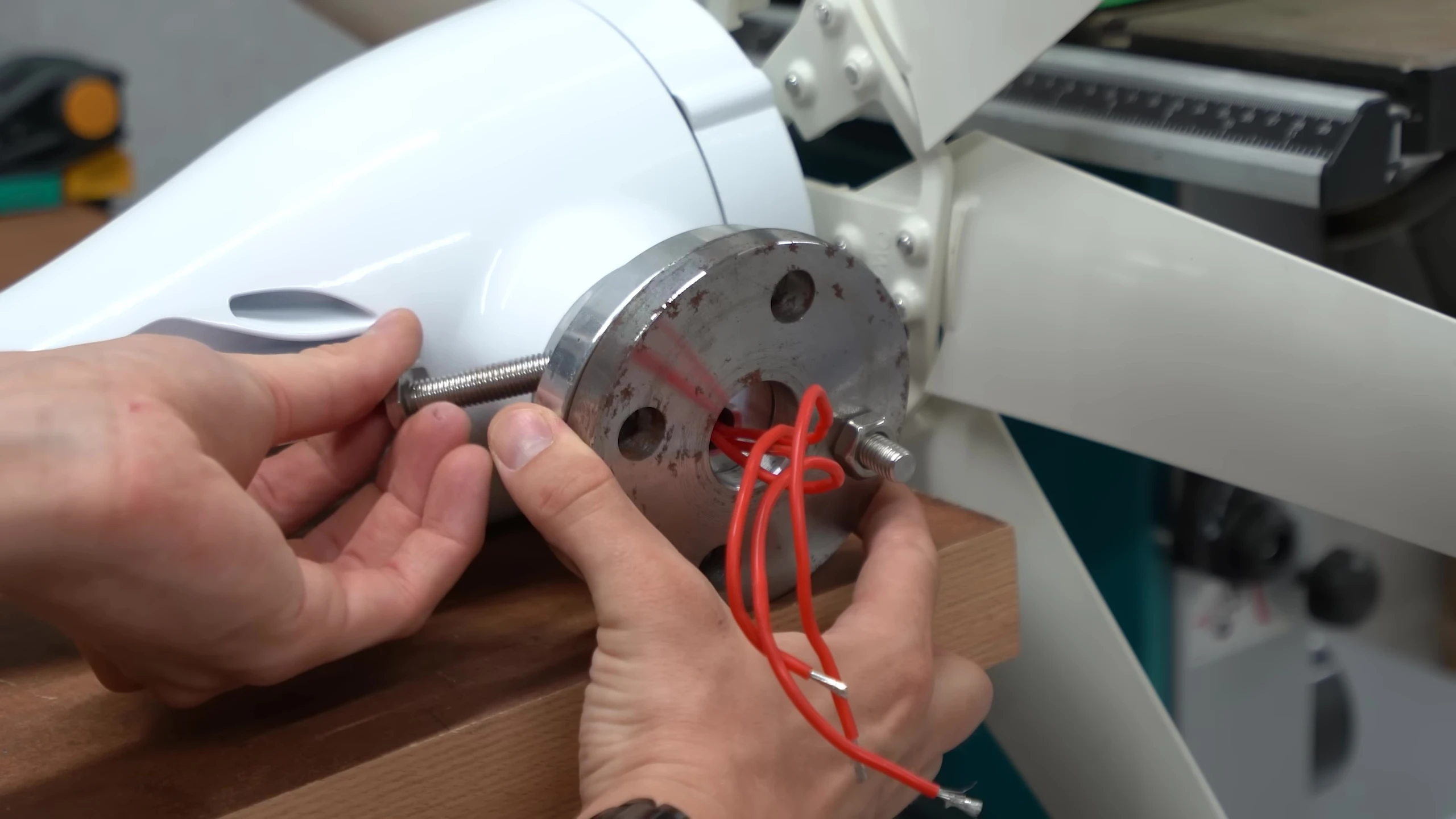 The metal flange and mounting hole of the wind generator.
