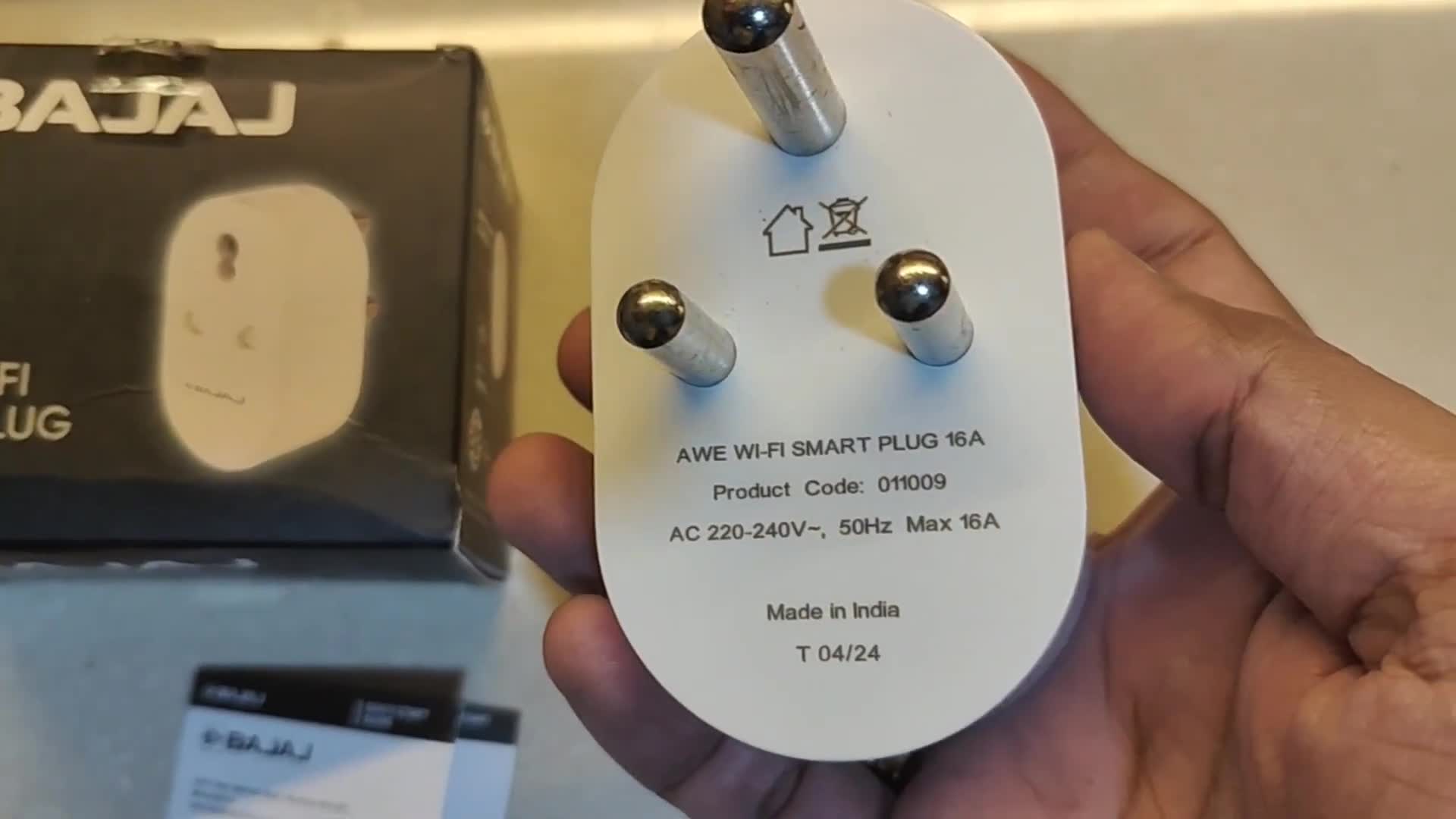 The Bajaj AWE 16 Amp Smart Plug and instruction manual inside the box.