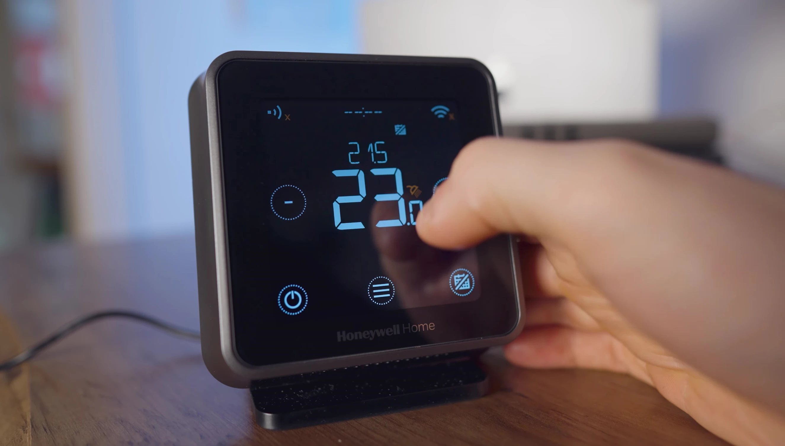 The thermostat display showing both current and target temperatures.