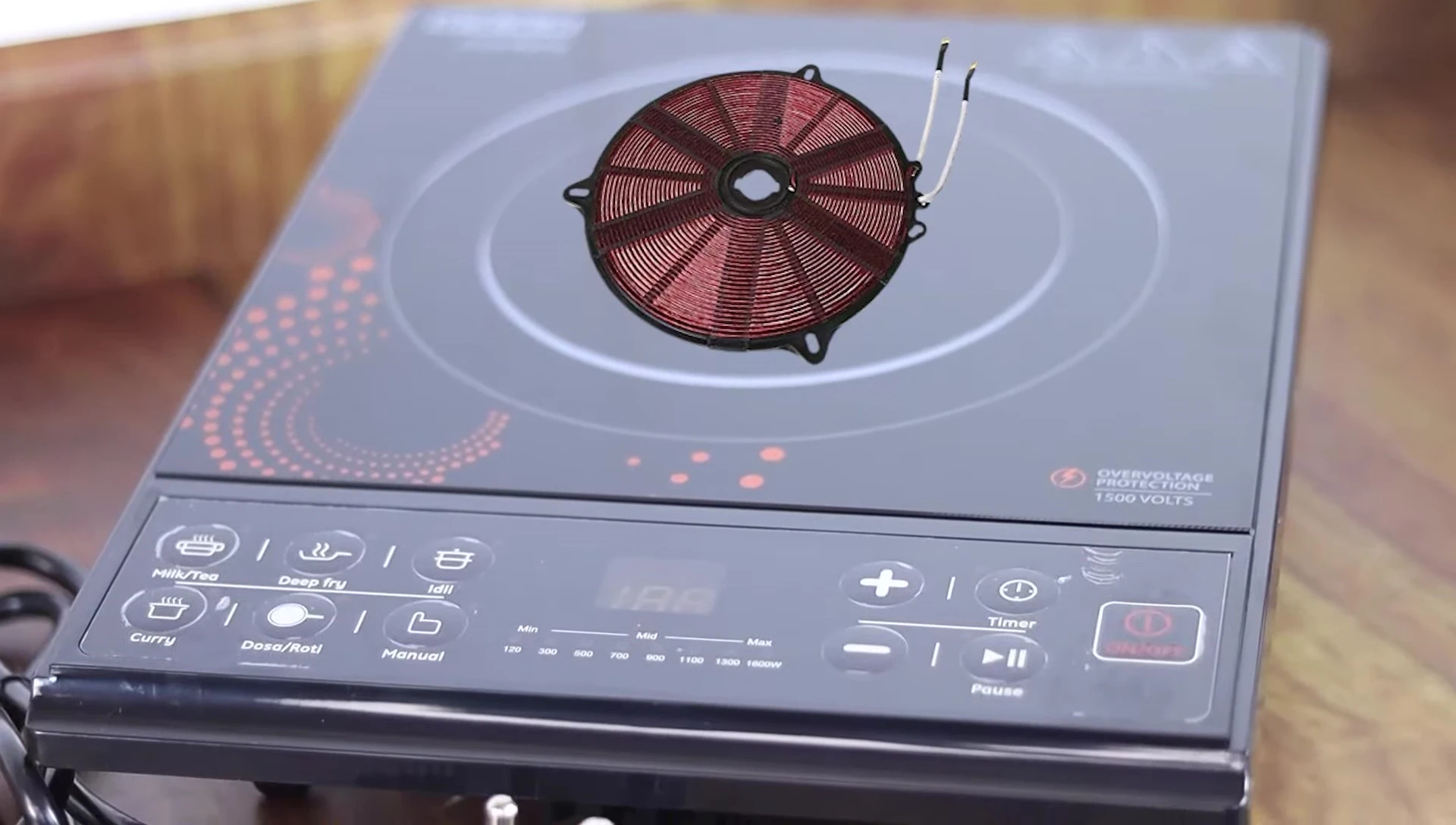Close-up of the copper coil inside an induction cooktop