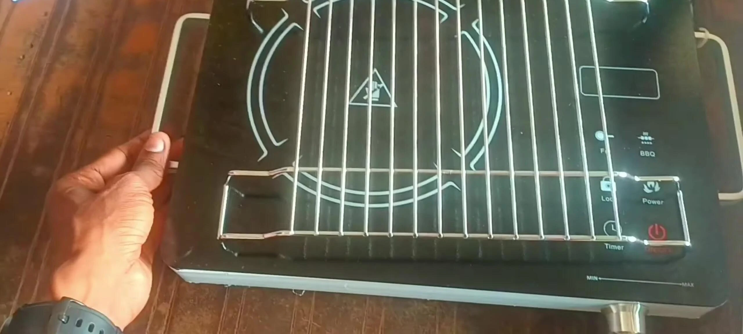 The handle on the side of the cooktop.
