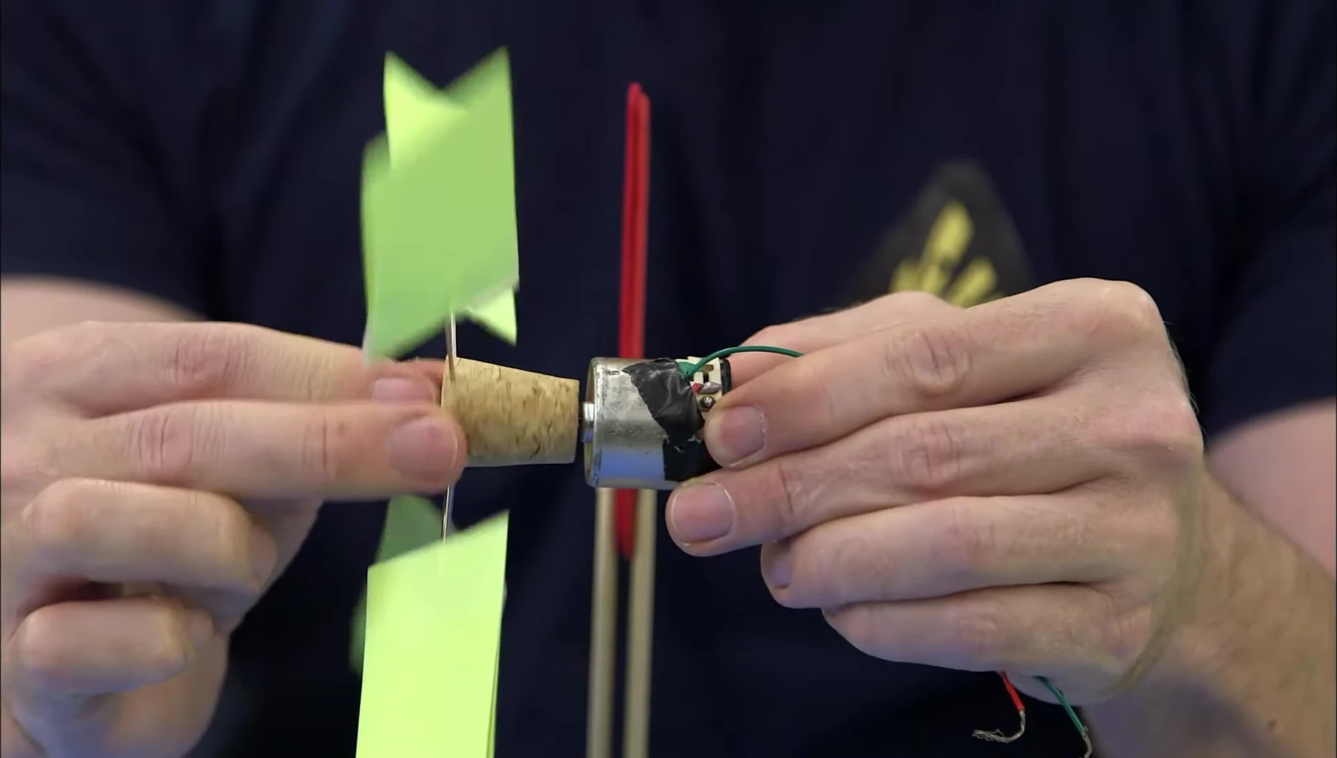 The complete assembly of the wind turbine, showing the motor secured between the craft sticks.