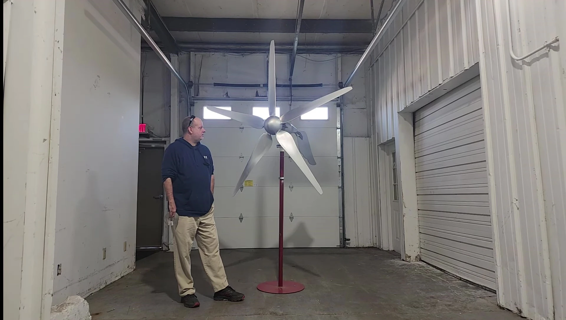 The presenter showing the simple components of the wind turbine