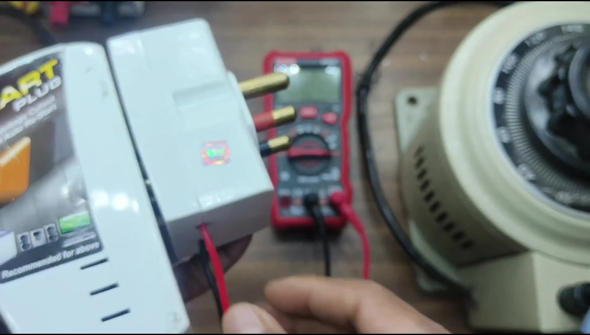 Screenshot showing the setup for testing the smart plug using a variable voltage source and multimeters.