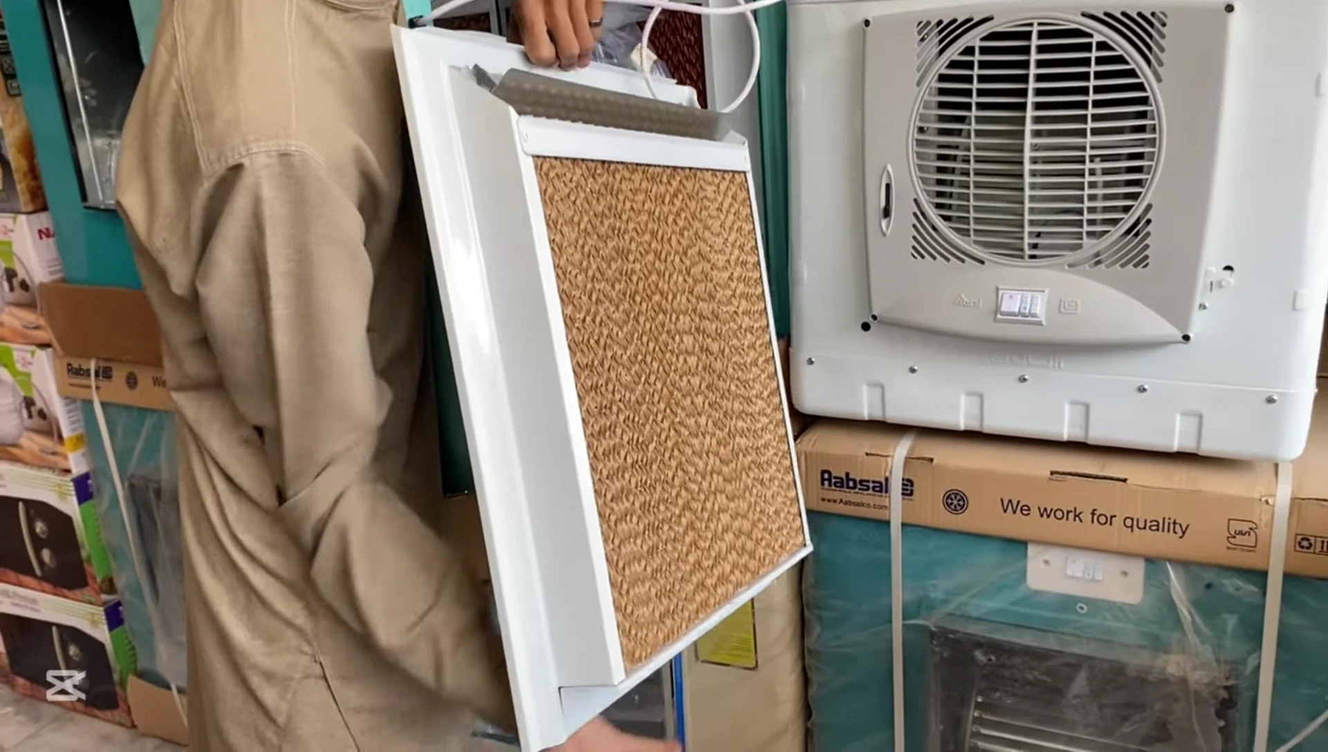 Seller demonstrating the cooling pads of the Irani cooler