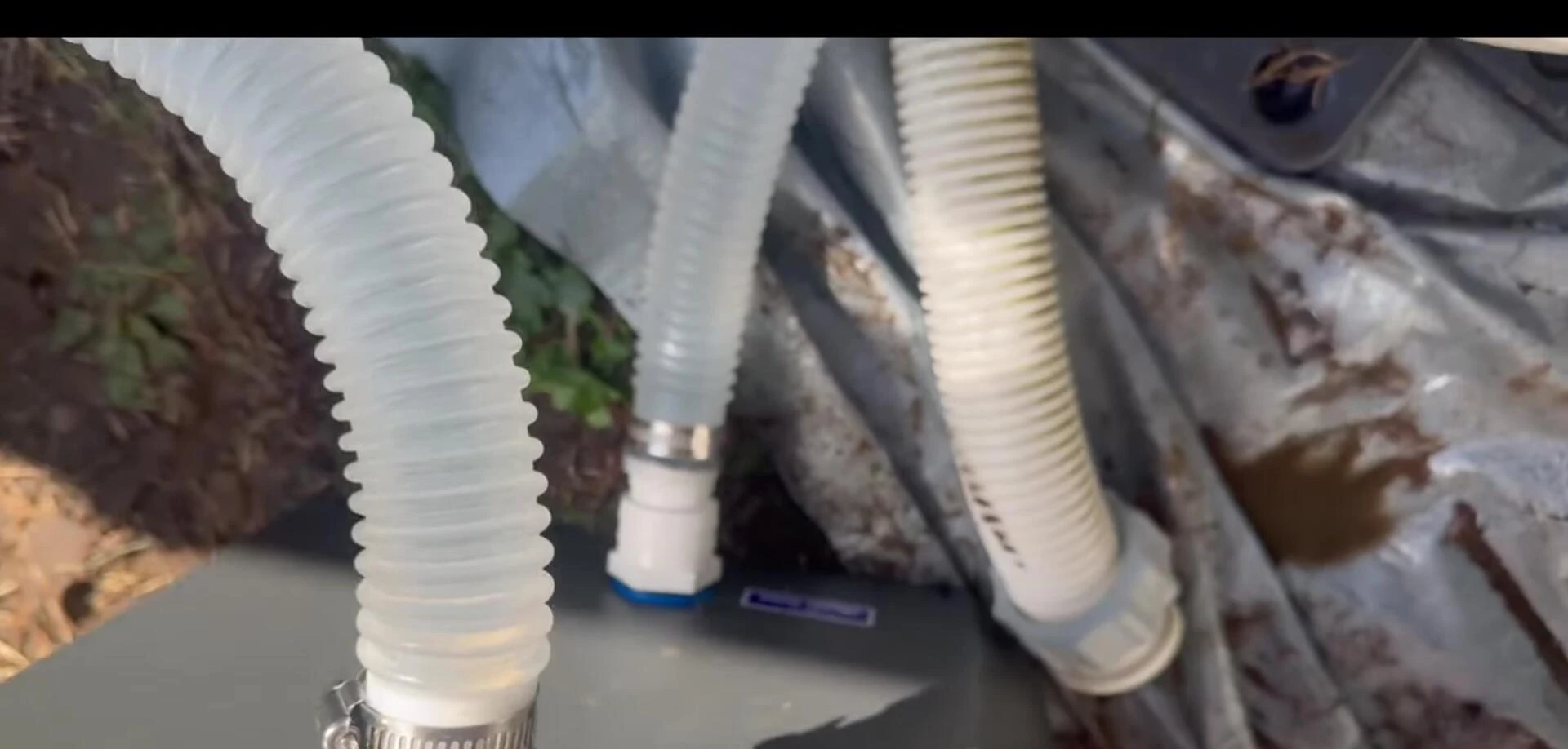 View of the back of the heat pump with the hose connections clearly visible.