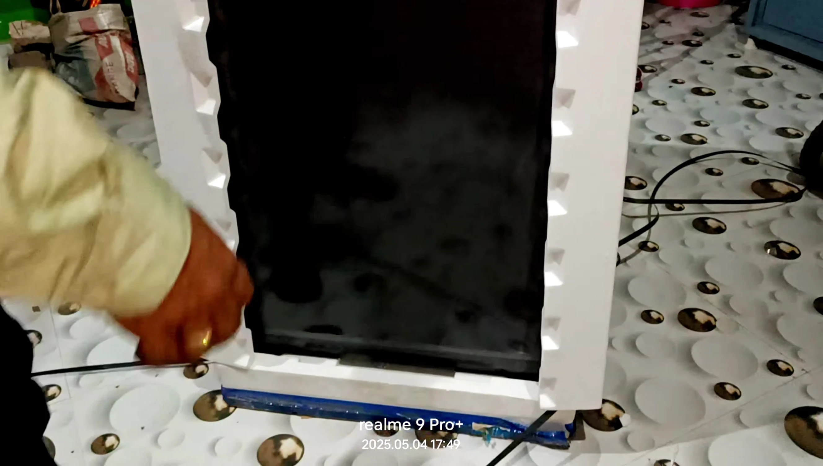The reviewer showing the grey color of the washing machine.
