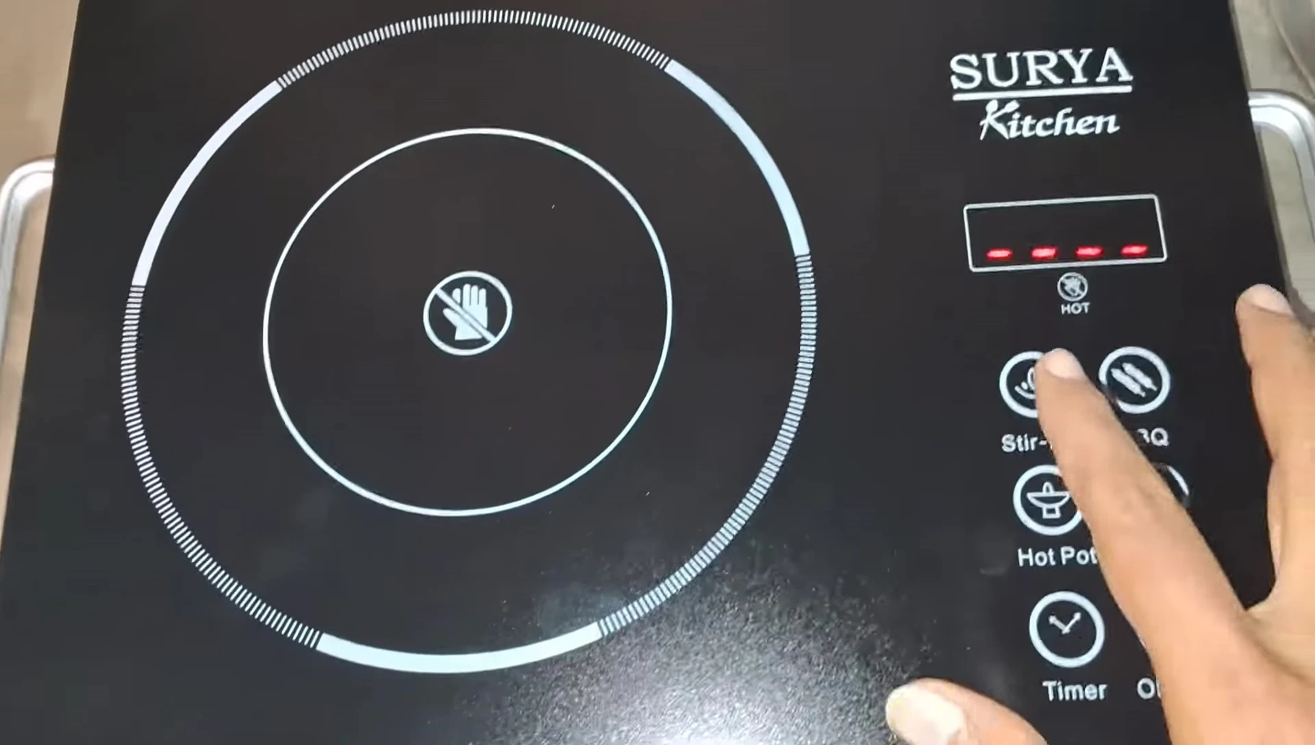 The cooktop's on/off button and power indicator light.