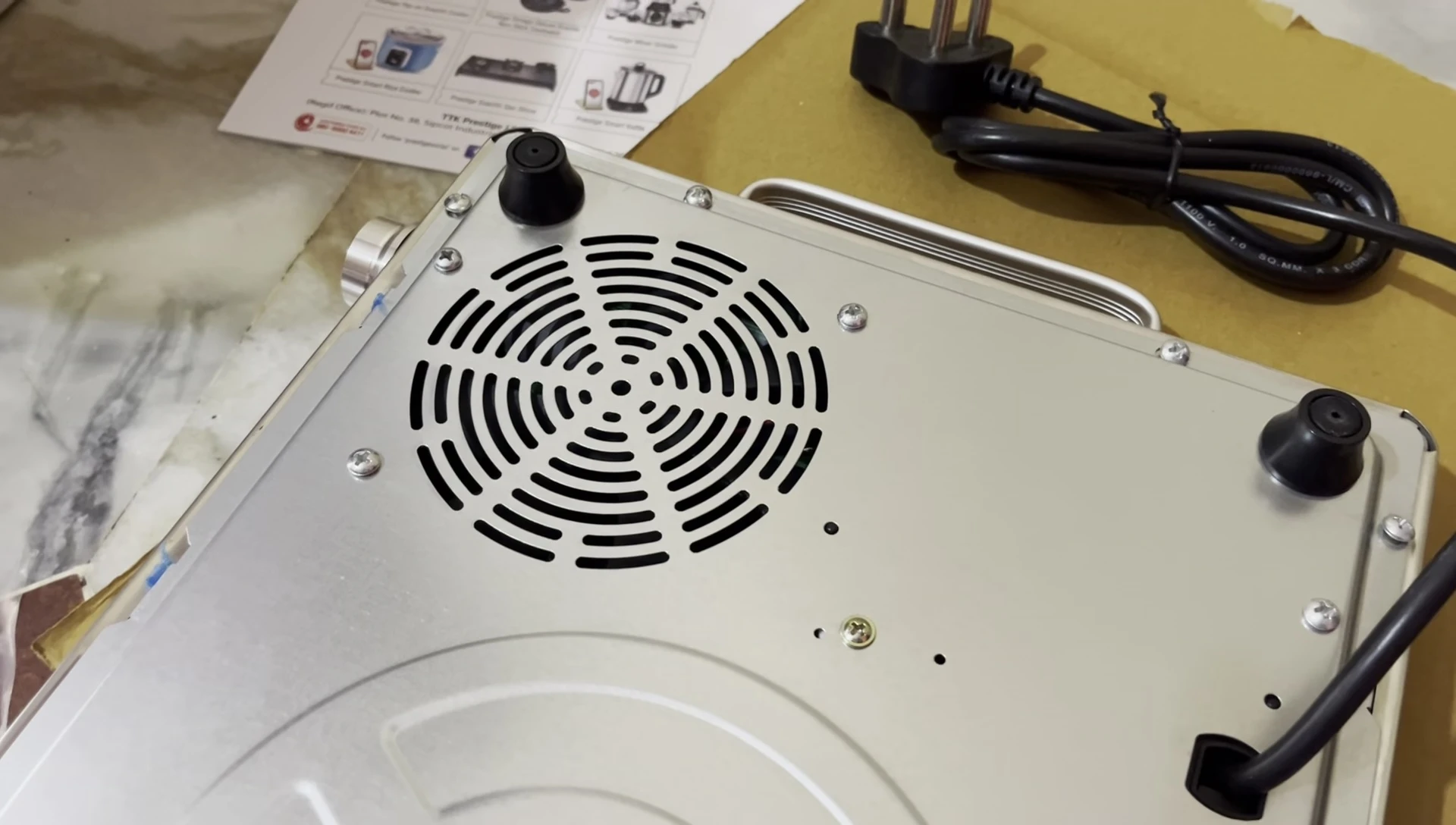 Rear view of the cooktop showing the fan and iron base