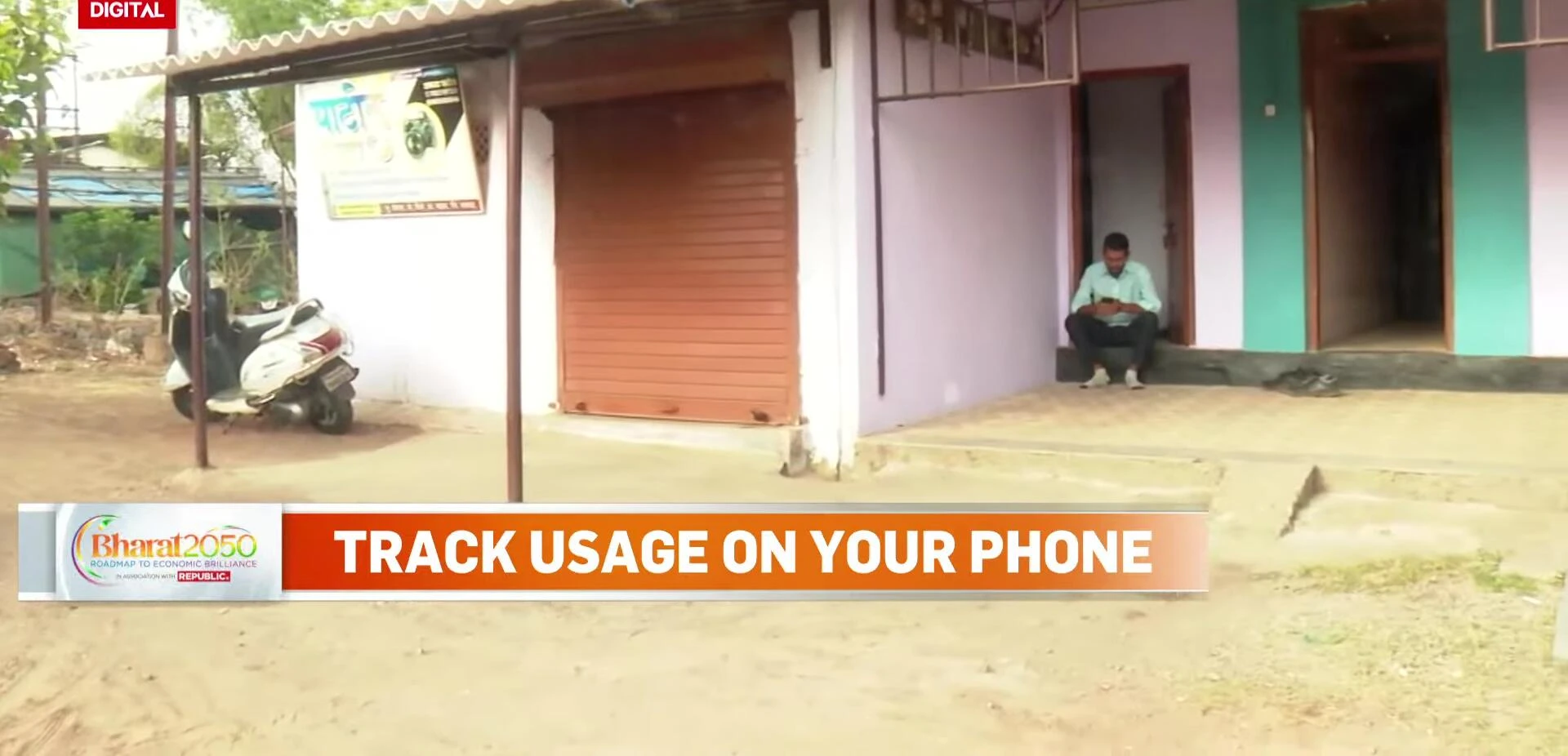Mangesh Pardhe using a smartphone to monitor his energy consumption.