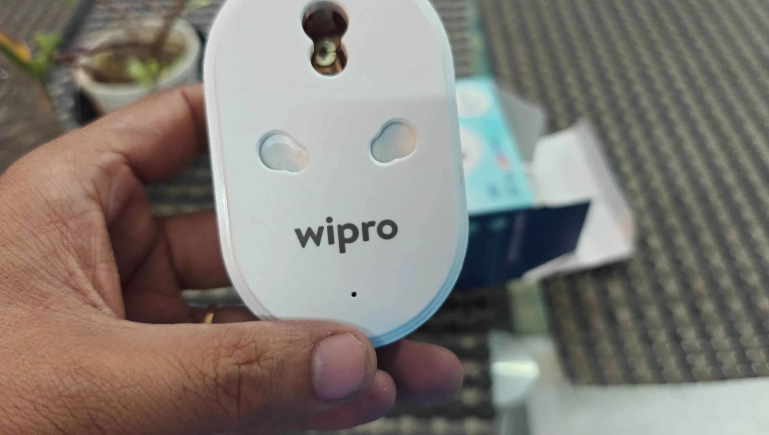 The smart plug connected to a power outlet