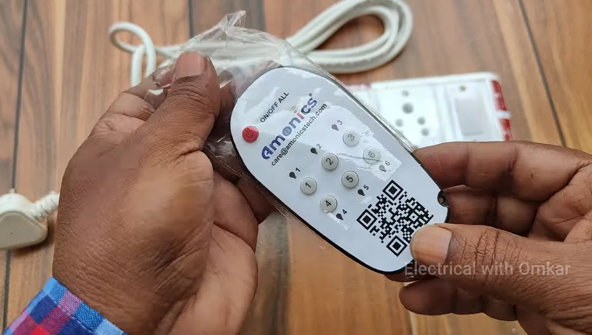Close-up of the remote control, highlighting the 'On Off All' button and individual socket controls.