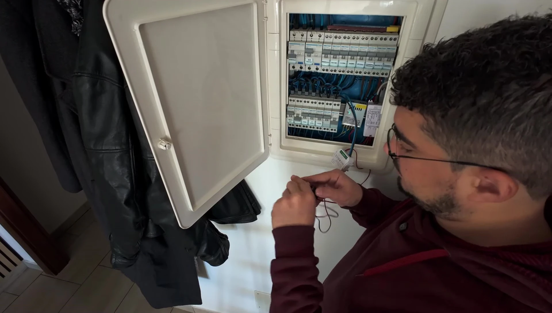 The speaker carefully installing a clamp around a wire, showing proper orientation of the clamp.