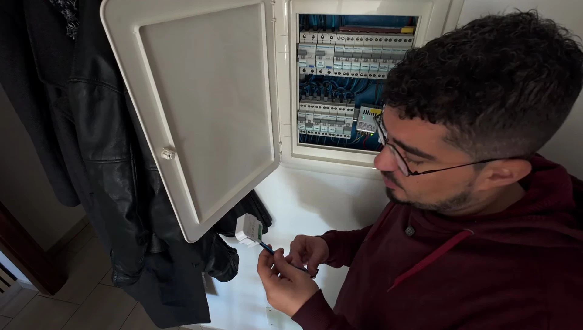 The device connected to the electrical panel, showing the connections and wiring.