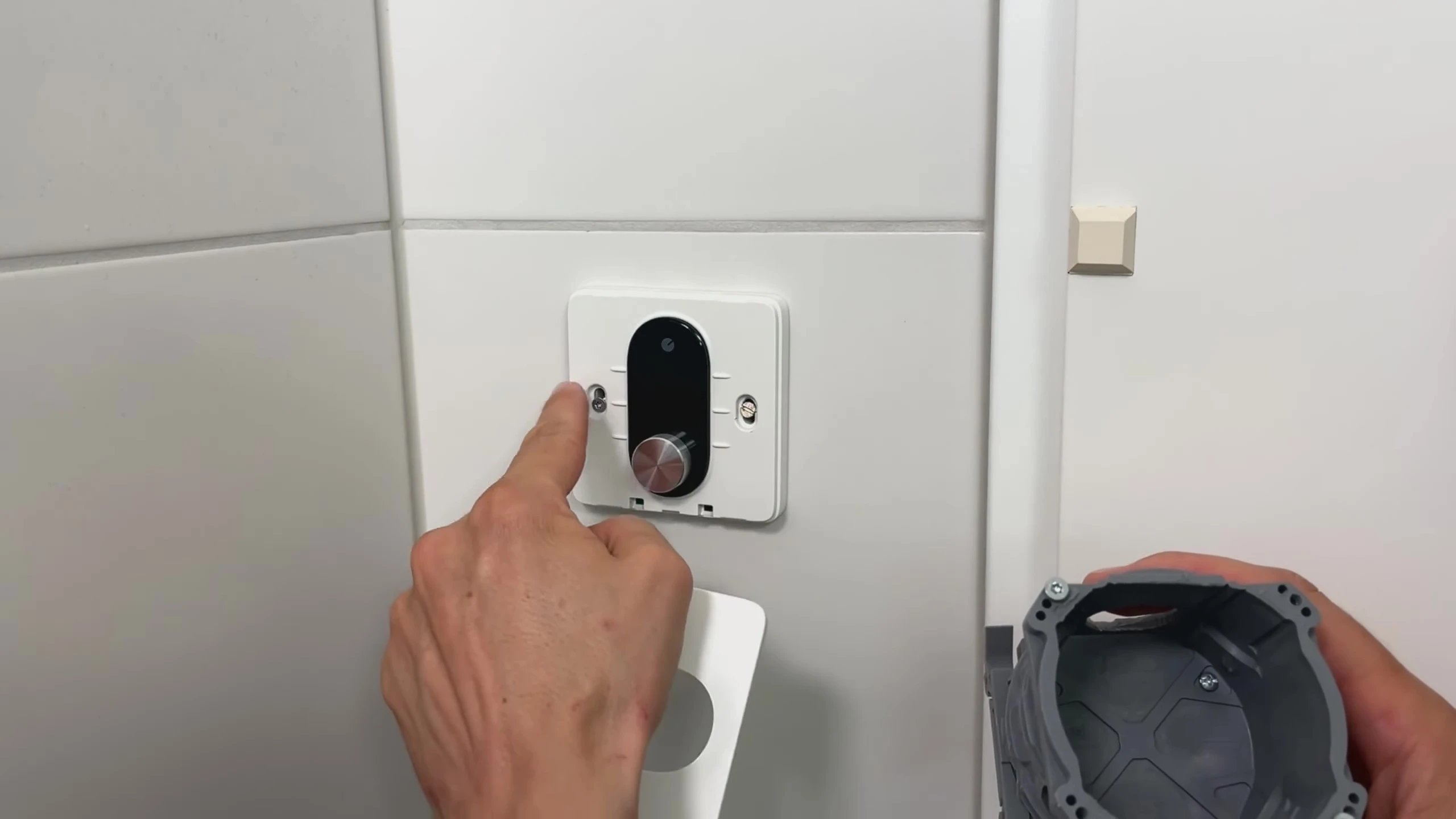 Close-up of the Shelly LinkedGo thermostat showing the mounting screws.
