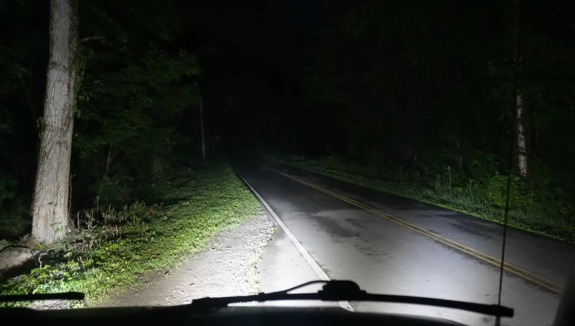 The van driving at night with the LED light bar illuminating the road.