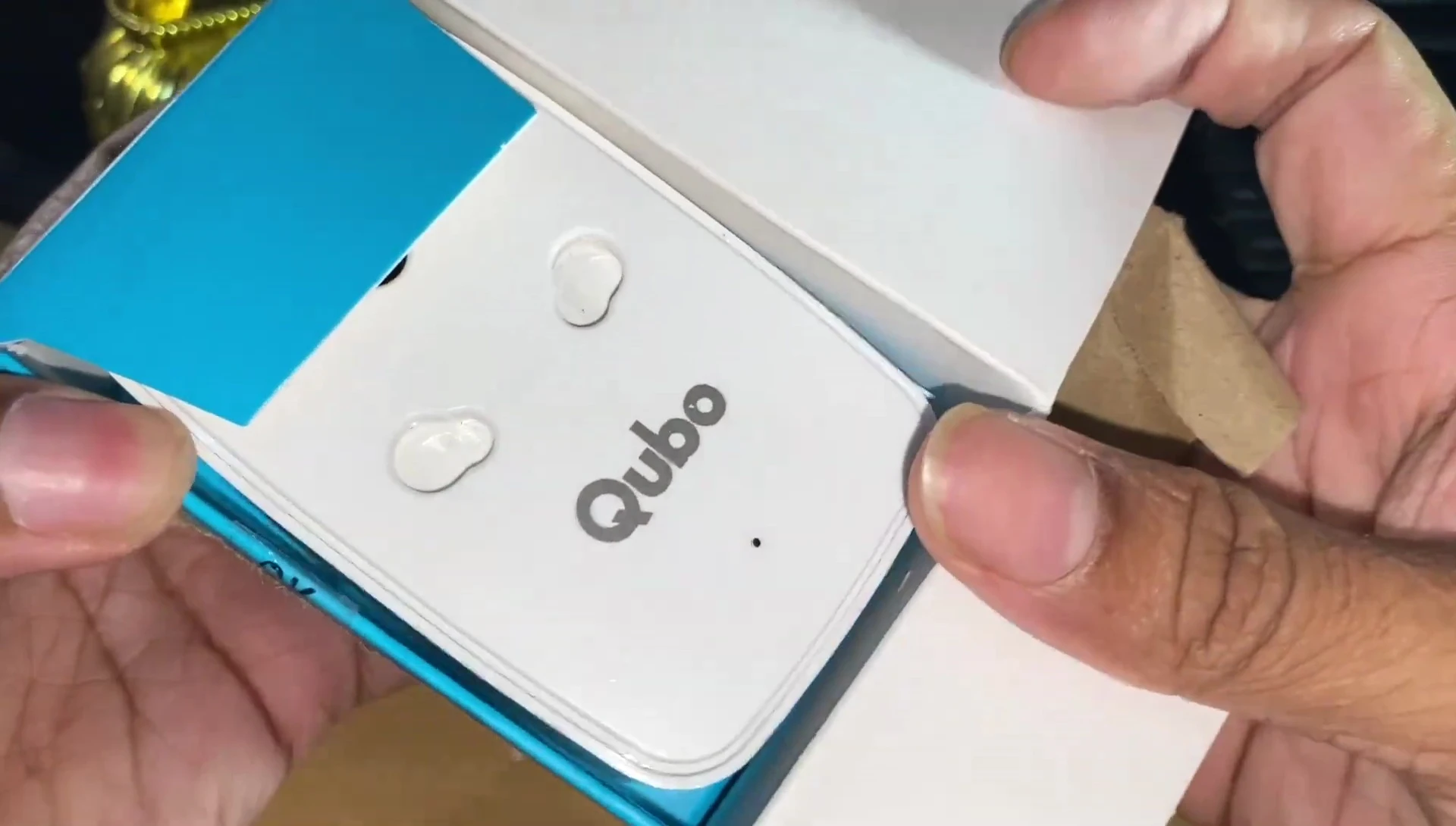 QUBO smart plug box being opened.
