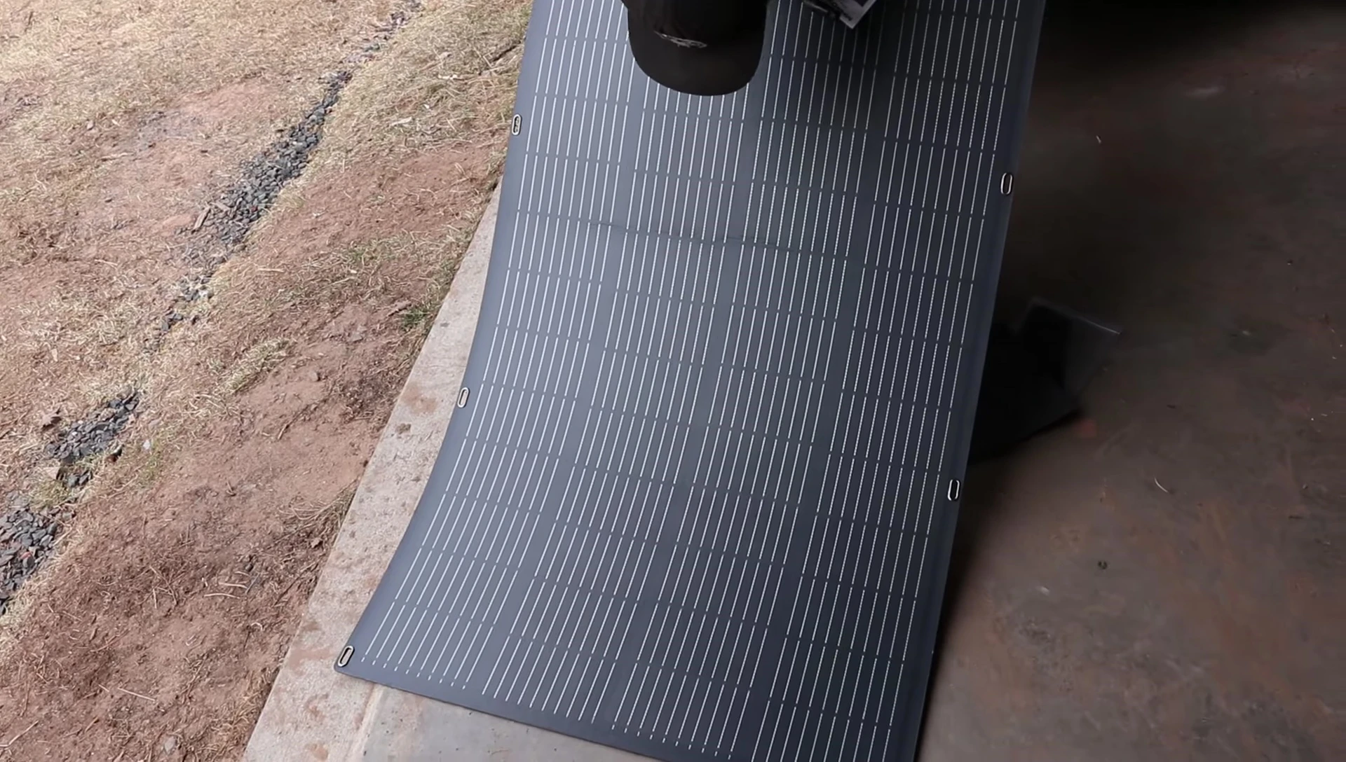 The solar panel being removed from its packaging, showing minor imperfections.