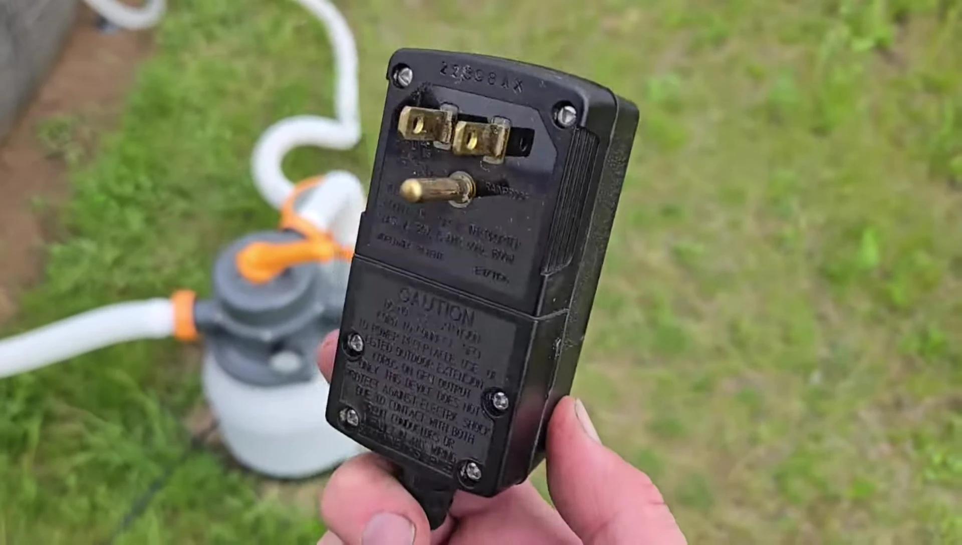 Standard plug being compared to a GFI plug