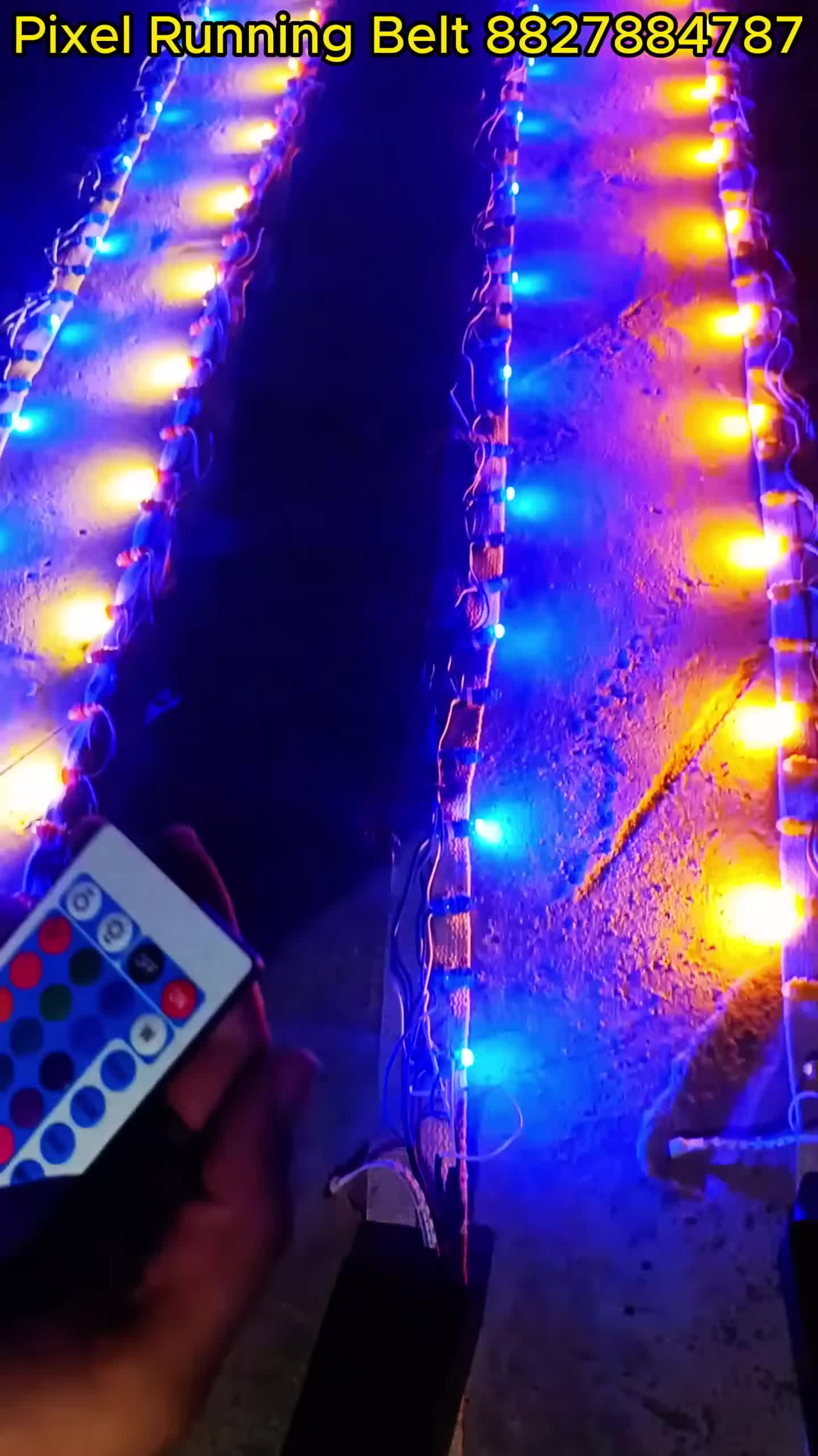 Close-up of the remote control being used to manipulate the running belt's lights