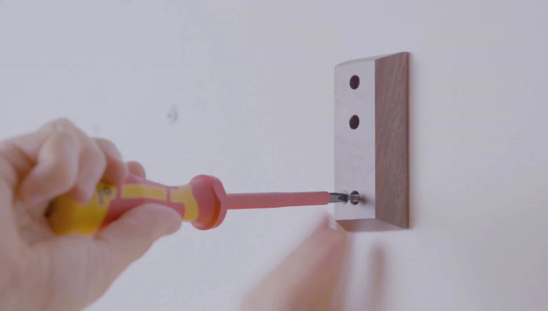 Using a level to ensure straight installation