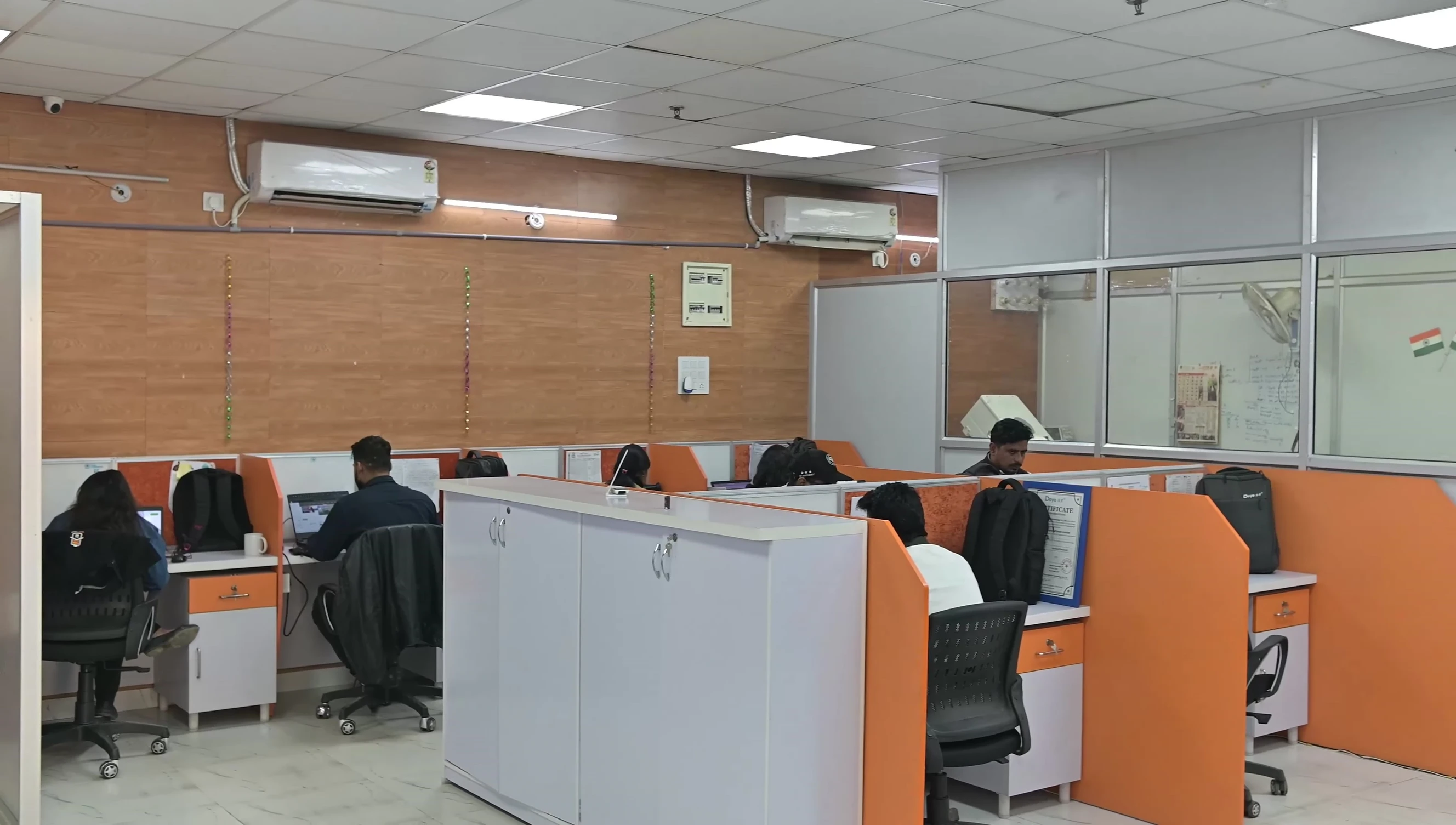 Watthut Electronics' pre-sale team members discussing system requirements with a customer.