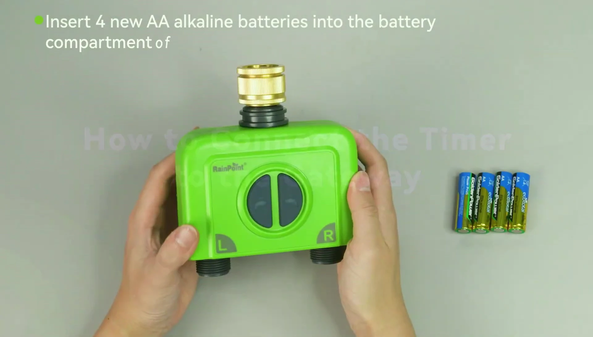 Close-up of inserting batteries into the water timer.