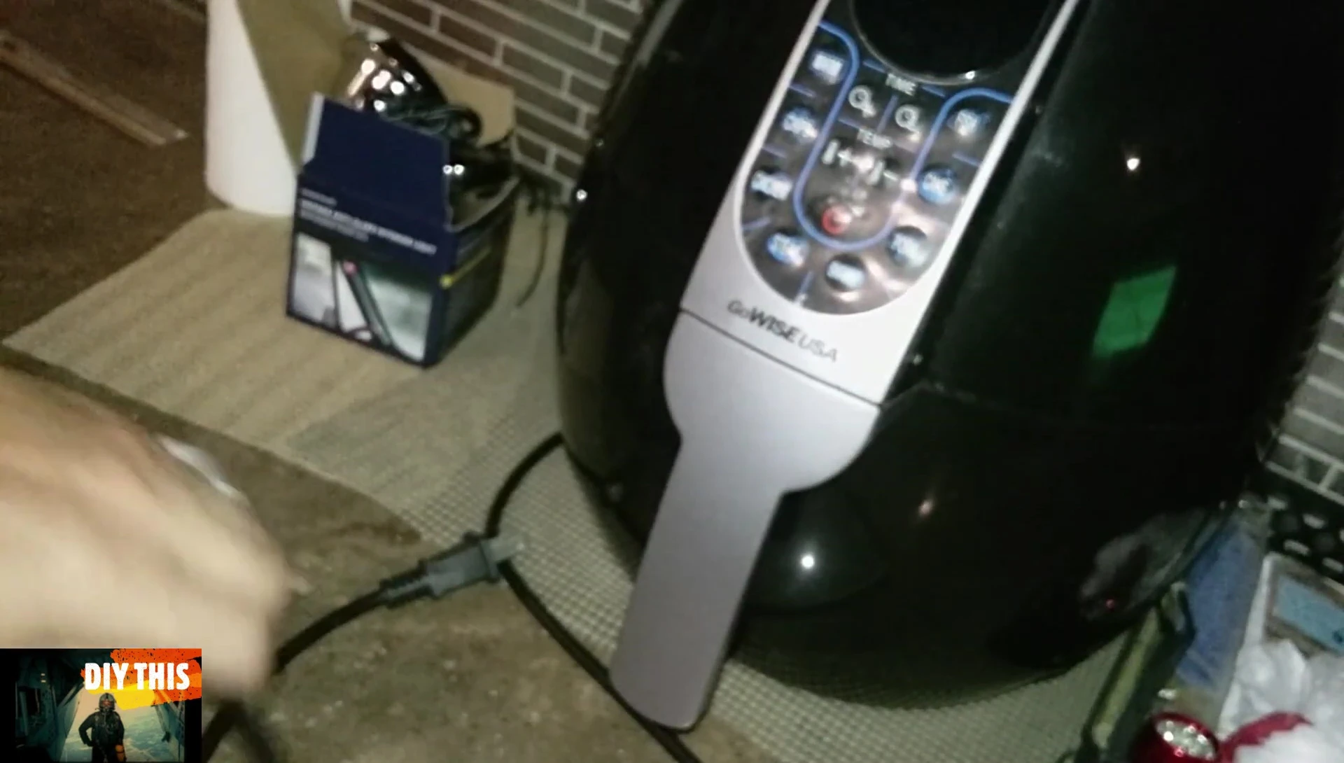 Final shot of the presenter with the smart plug and appliance