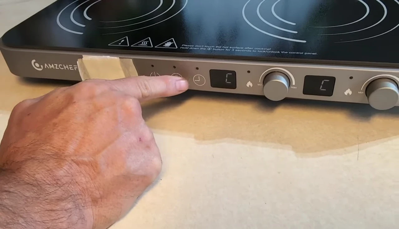Close-up of the control panel showing power, timer, and lock buttons