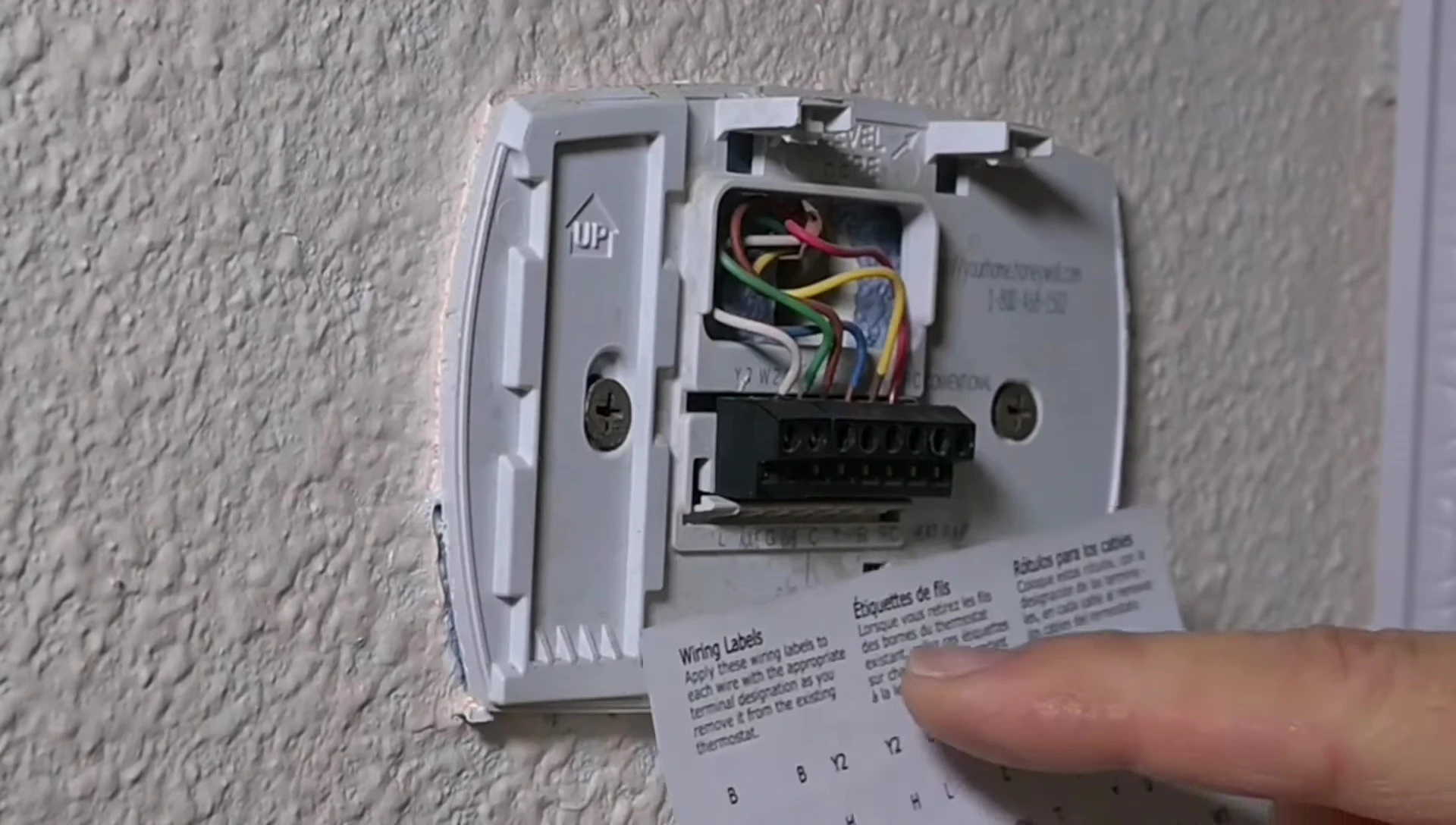Close-up of the labeled wires and new thermostat terminals