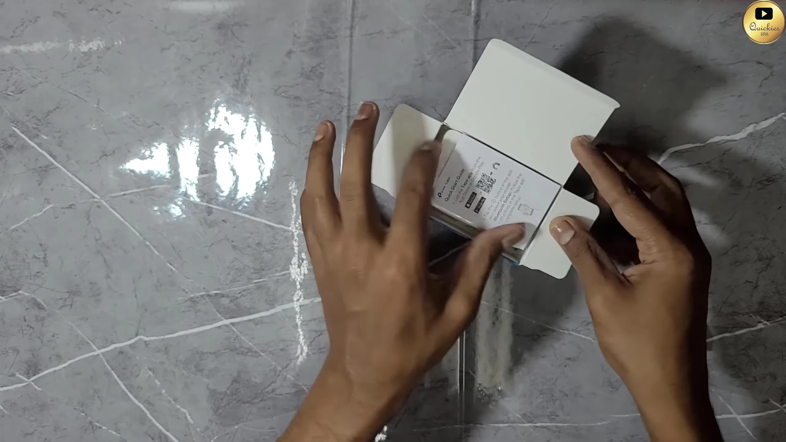 Unboxing the Tapo P110 smart plug, showing the user manual and quick start guide.