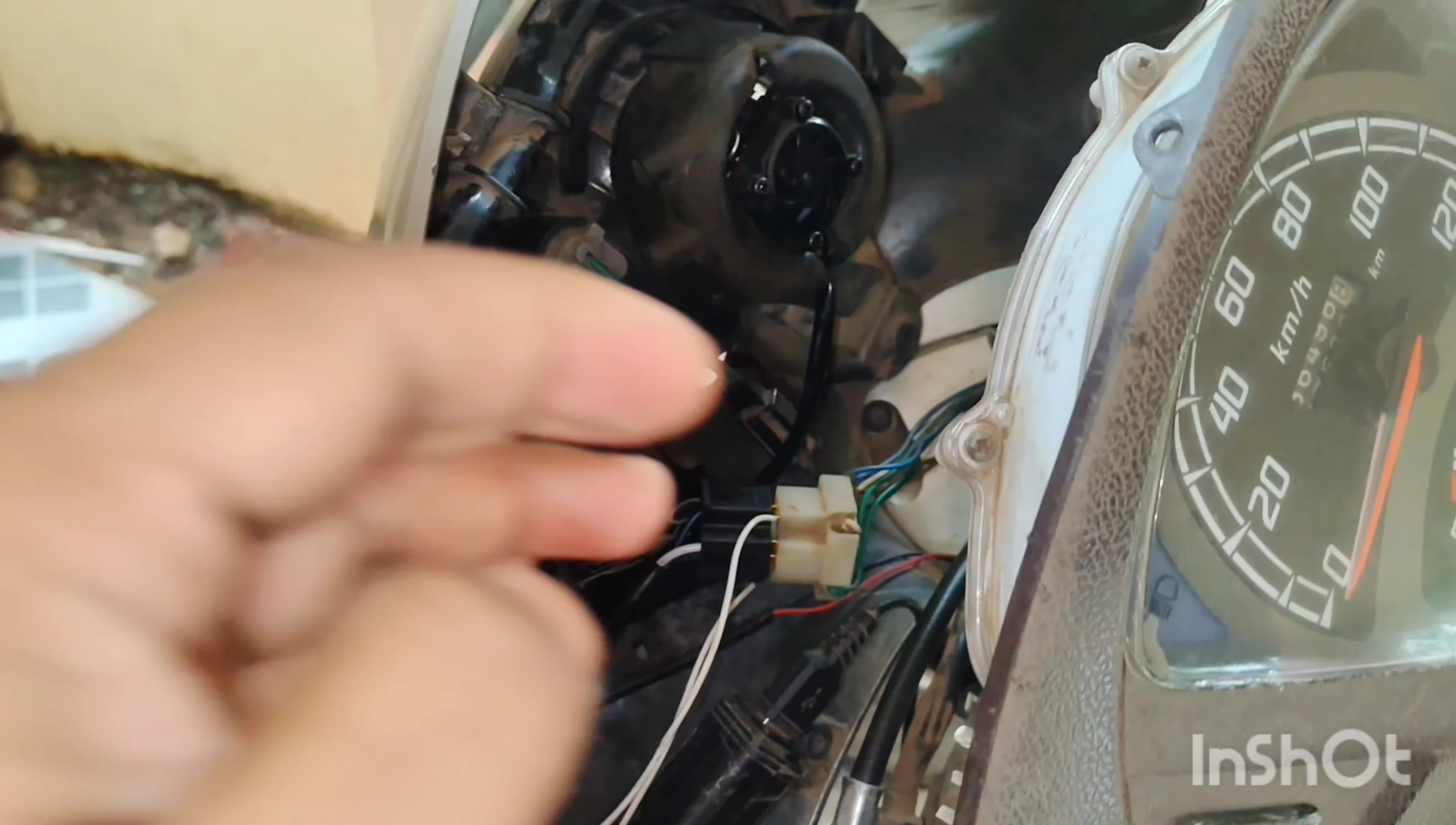 Removing the old LED unit from the housing.