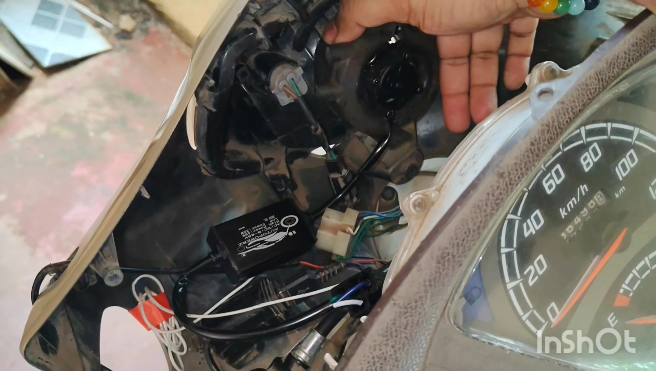 The old LED unit partially removed from the housing
