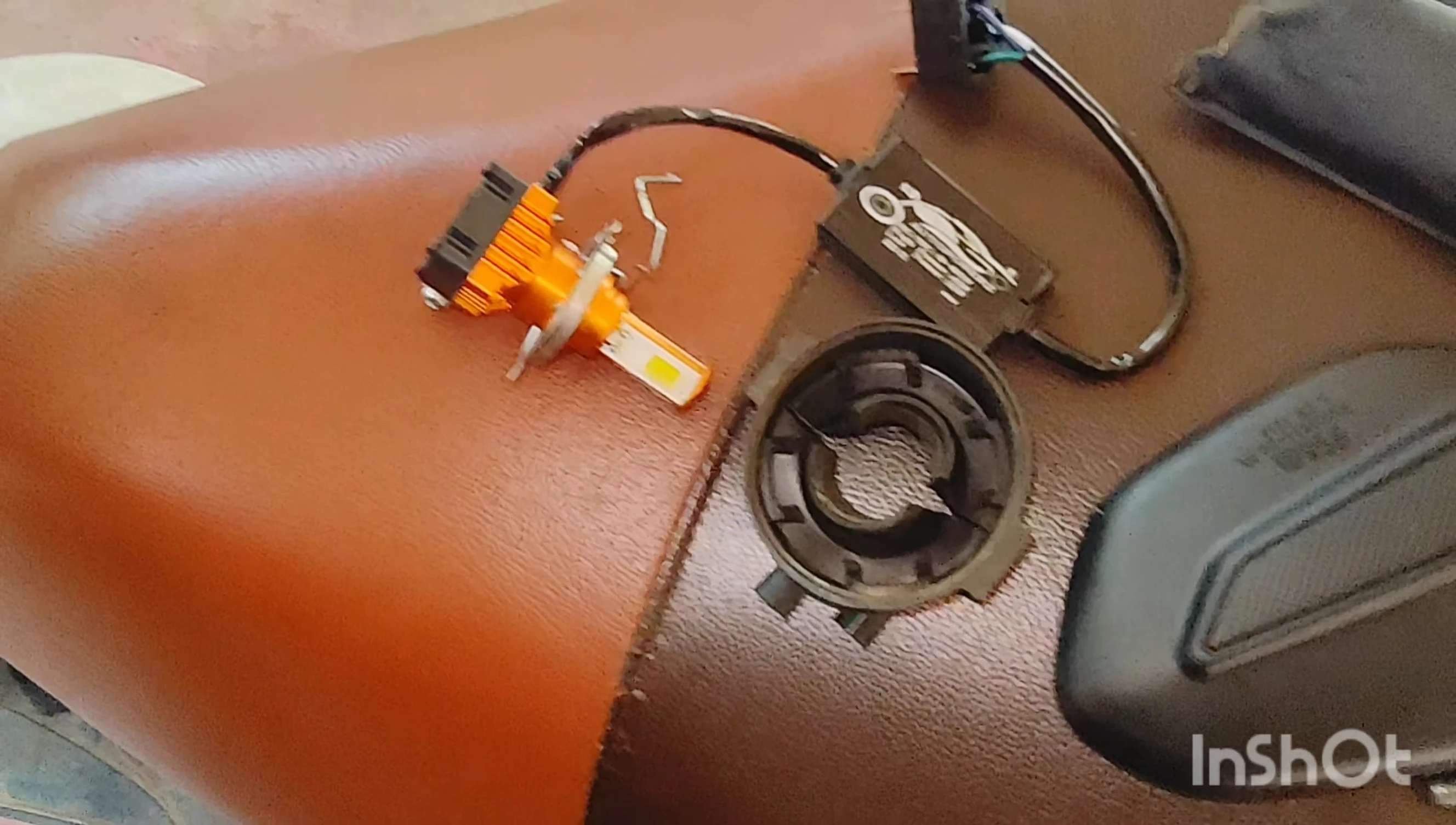 Inserting the new LED unit into the headlight housing.
