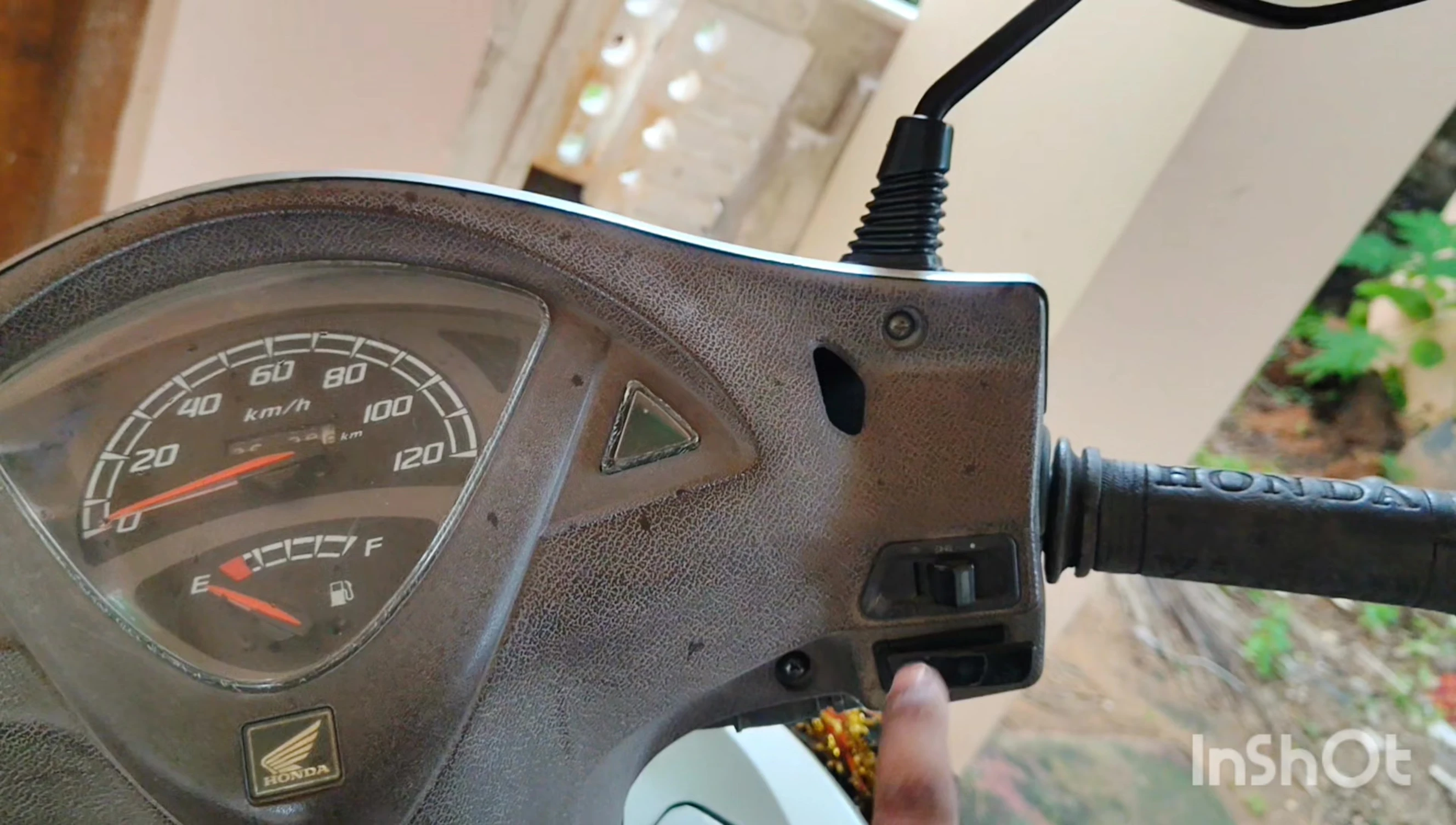 Close-up of the two nuts securing the headlight assembly.