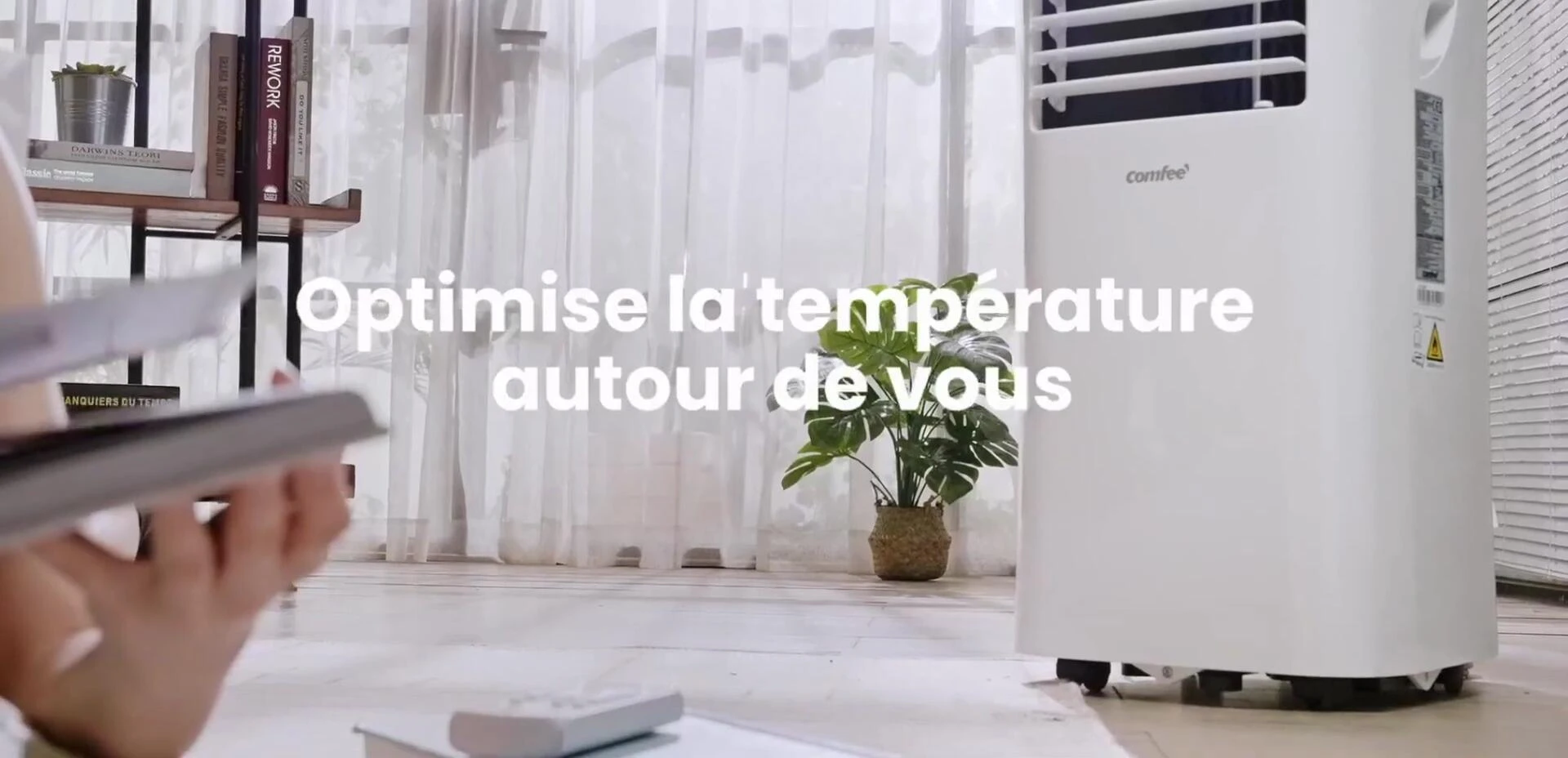 The air conditioner's wheels and handle are highlighted, emphasizing its portability.