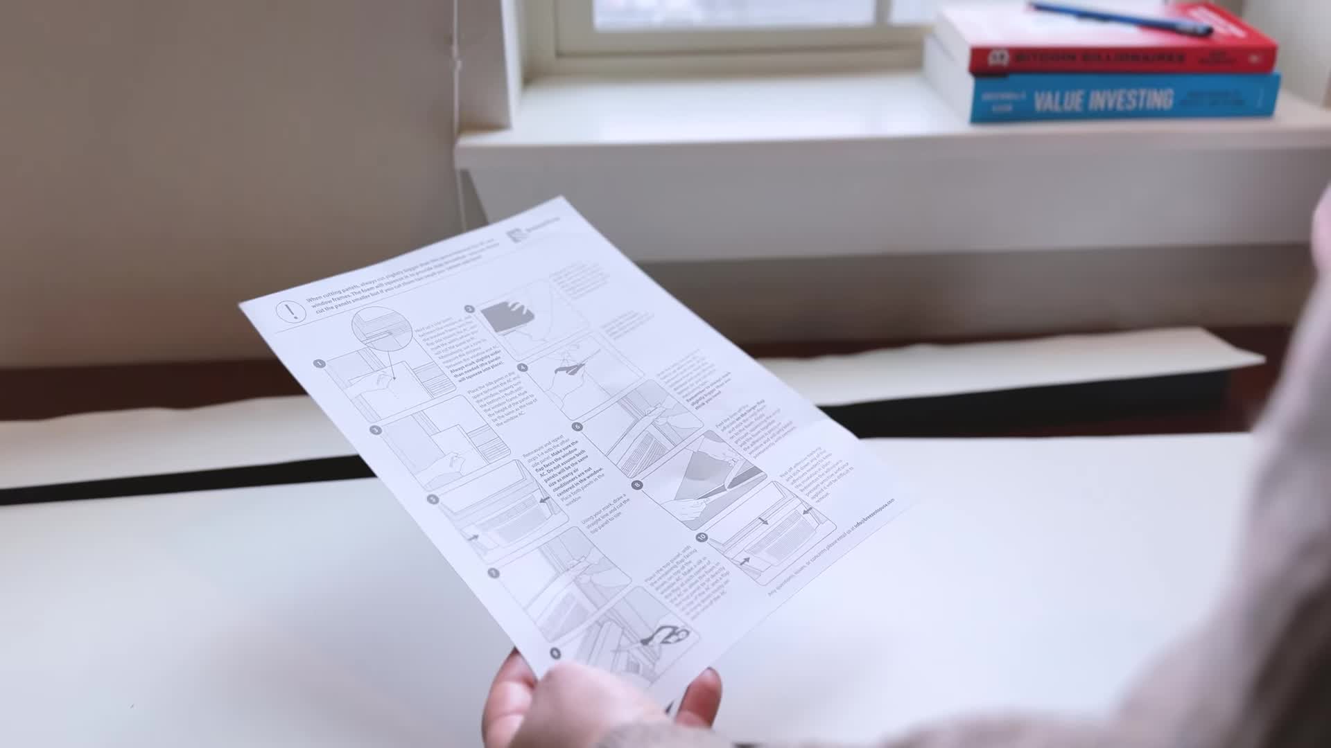 Measuring the space between the AC unit and window frame.