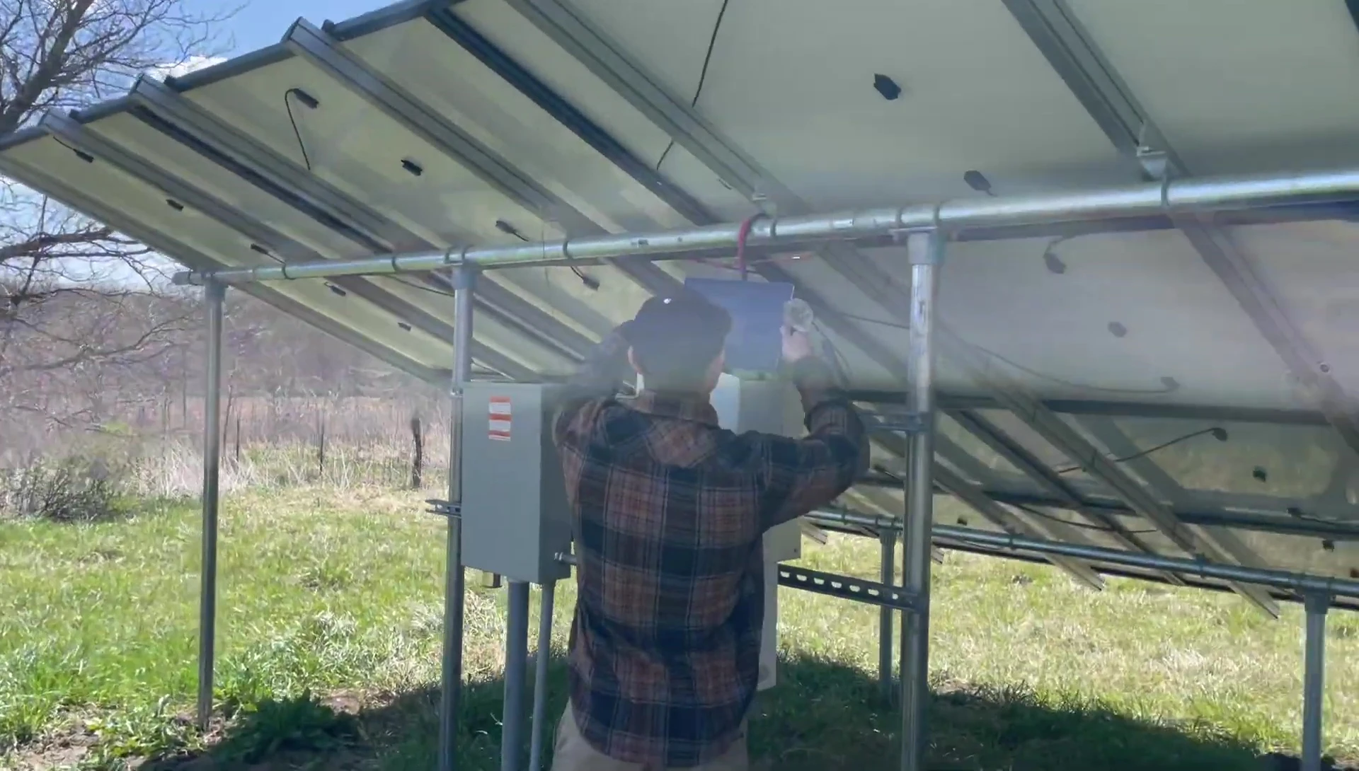 Wide shot showing the complete installation, including solar panels and the Skyream turbine.